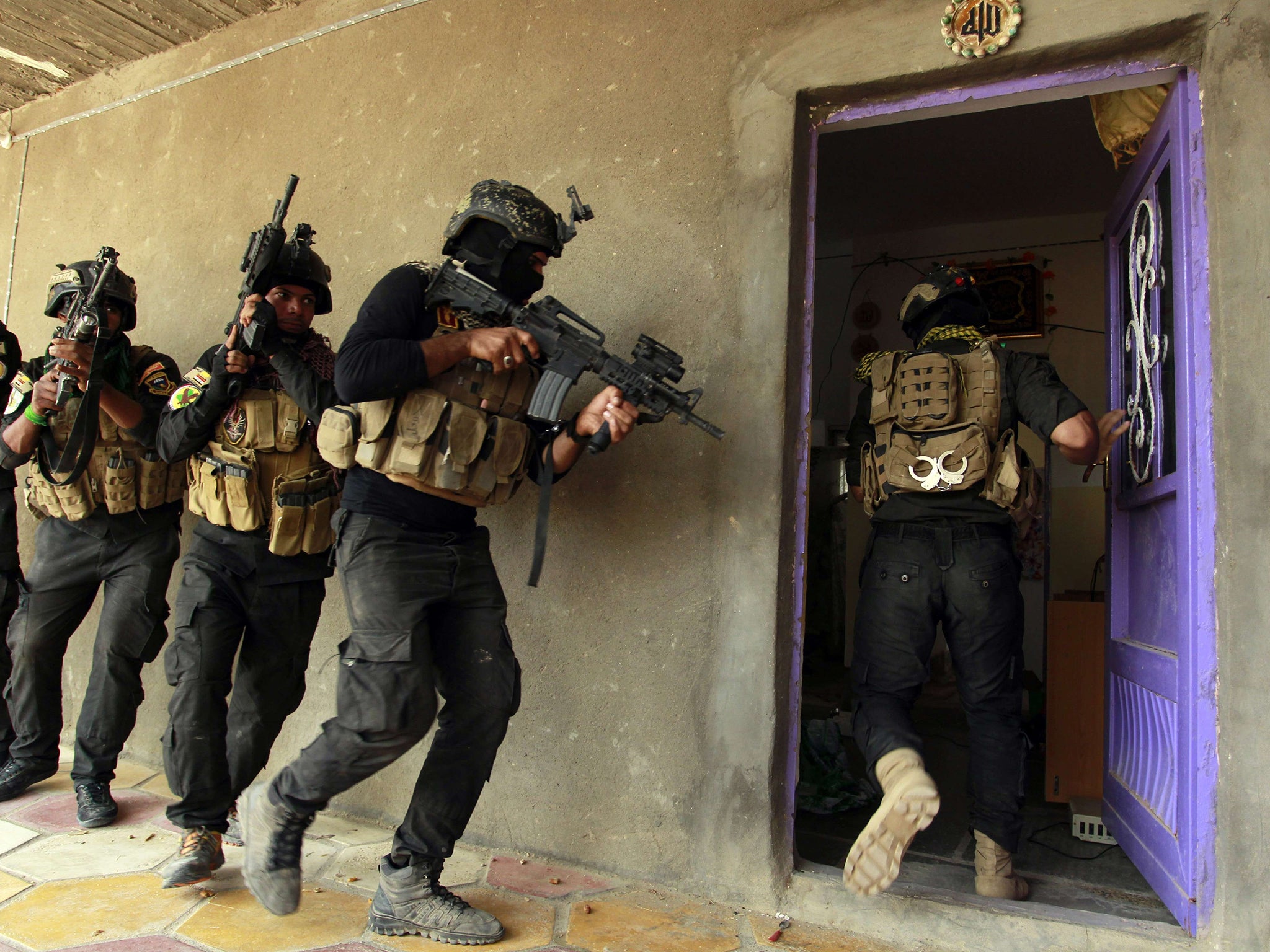 Iraqi special forces search a house yesterday after retaking Jurf al-Sakhar, north of
the Shia shrine at Karbala