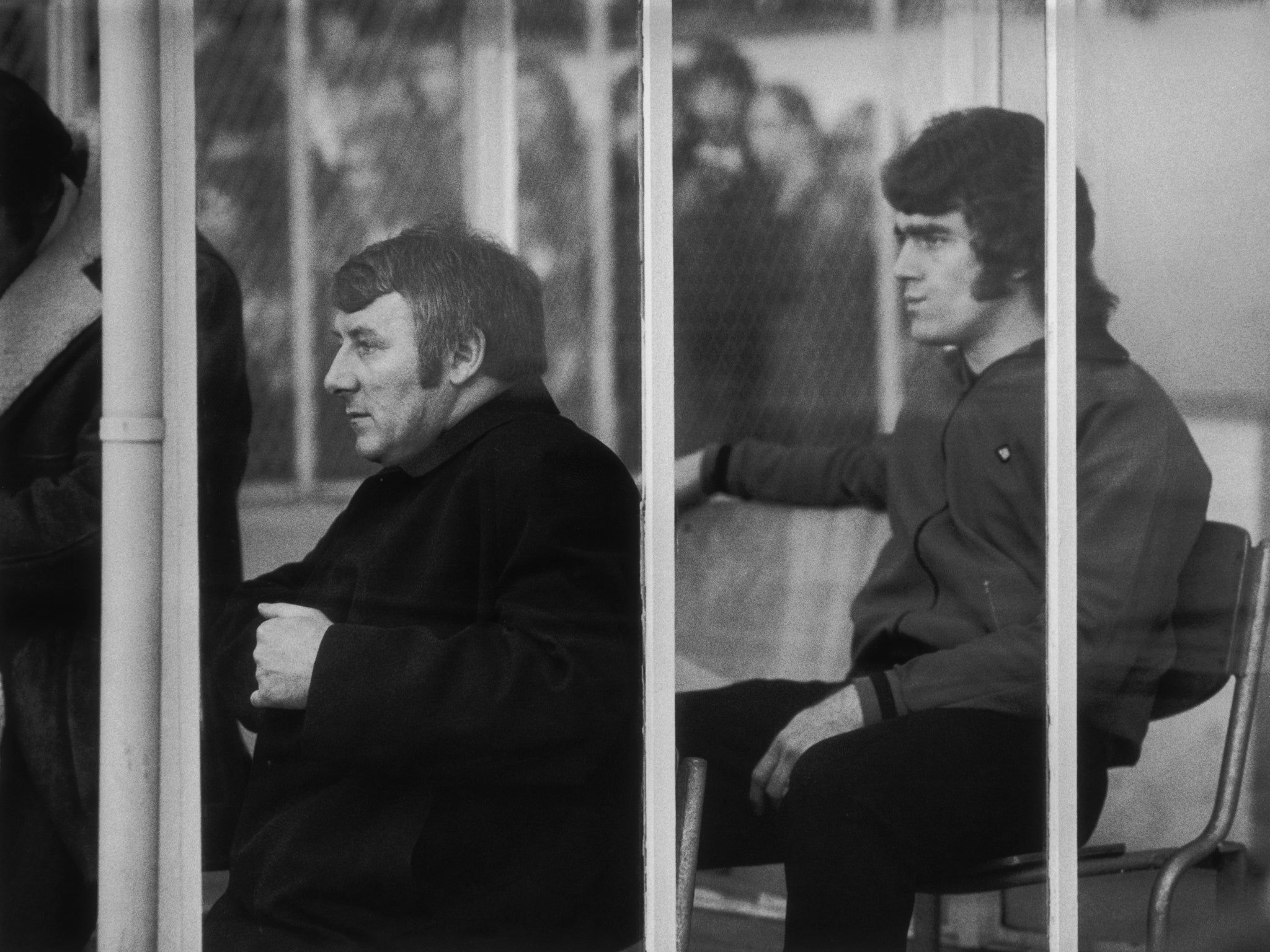 Tommy Docherty (left) as Manchester United manager on the bench during a match against Arsenal, 6th January 1973. Behind him is United sub Ted MacDougall