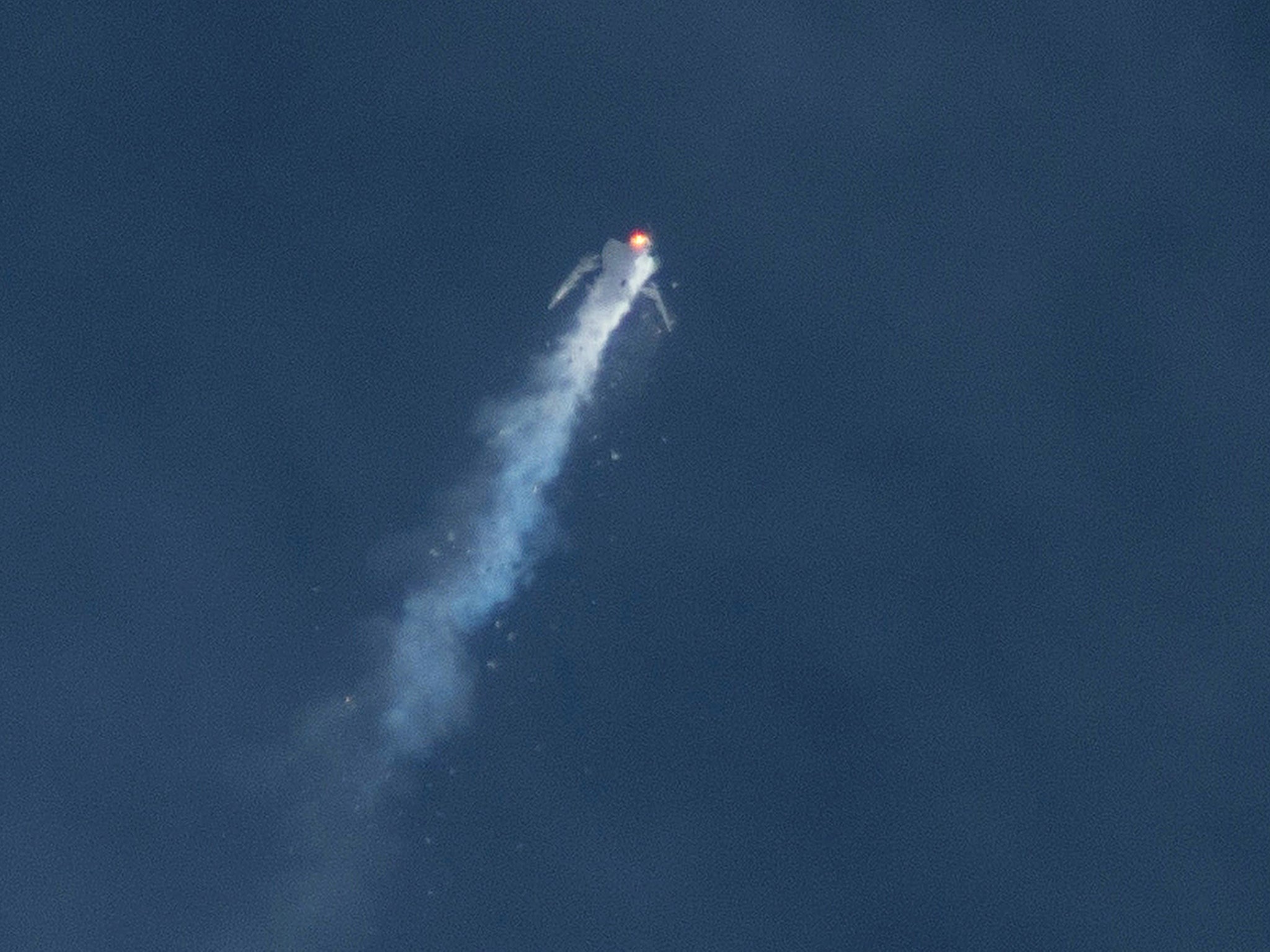 The Virgin Galactic SpaceShipTwo rocket explodes in the air during a test flight