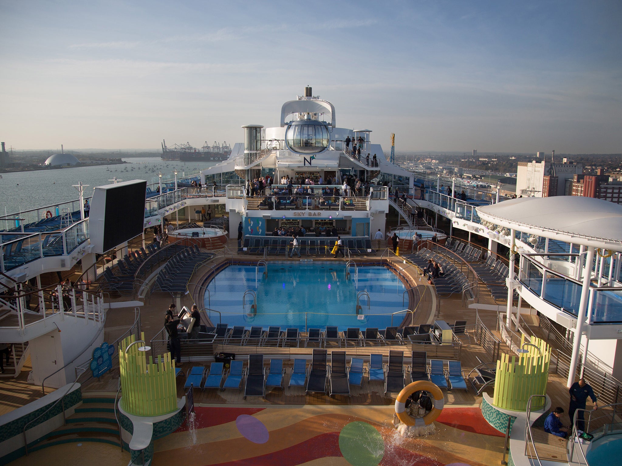 People sit and enjoy the facilites on the top deck onboard the cruise ship Quantum of the Seas