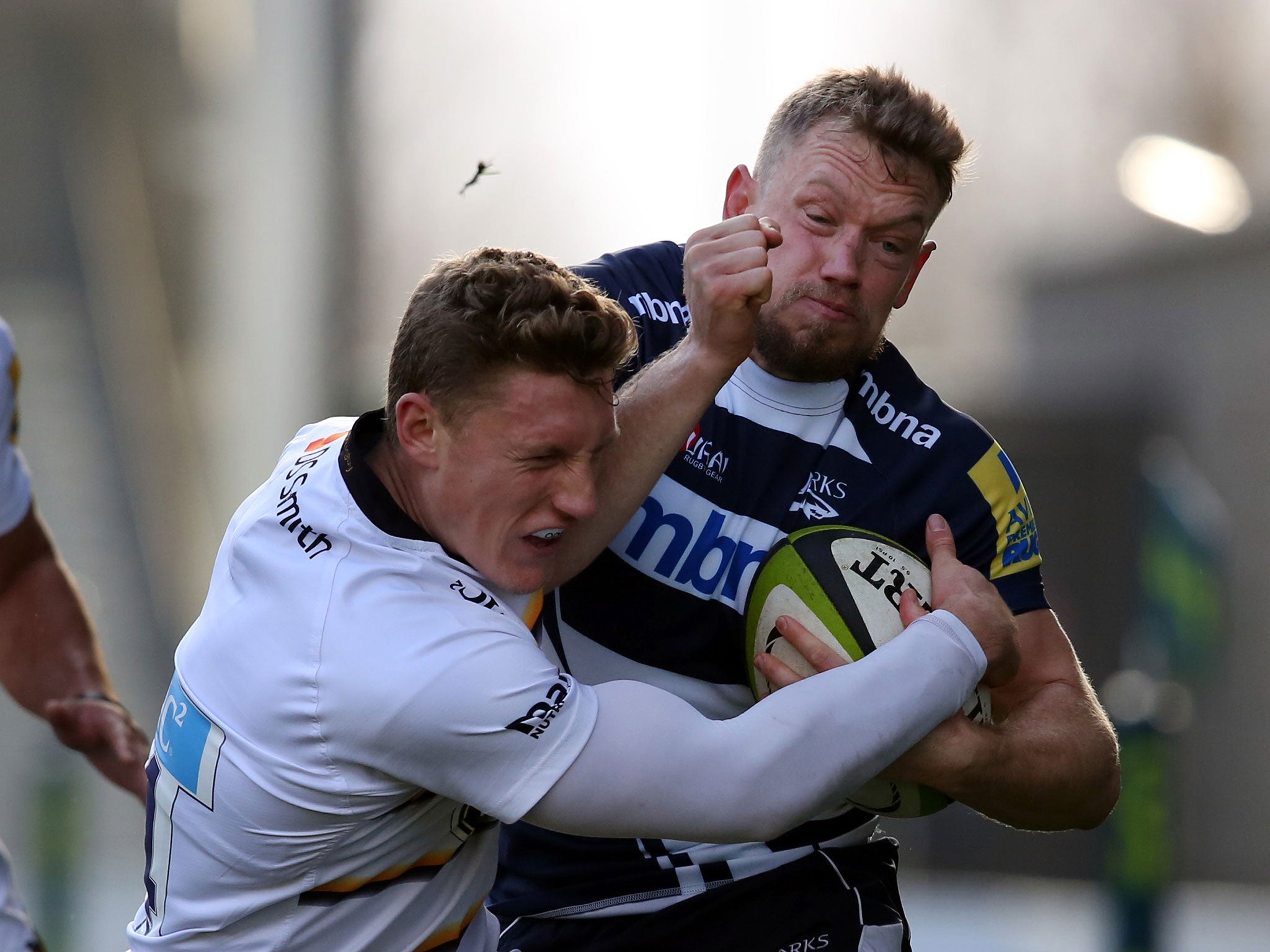 Phil Mackenzie of Sale is tackled by Tom Howe of Wasps