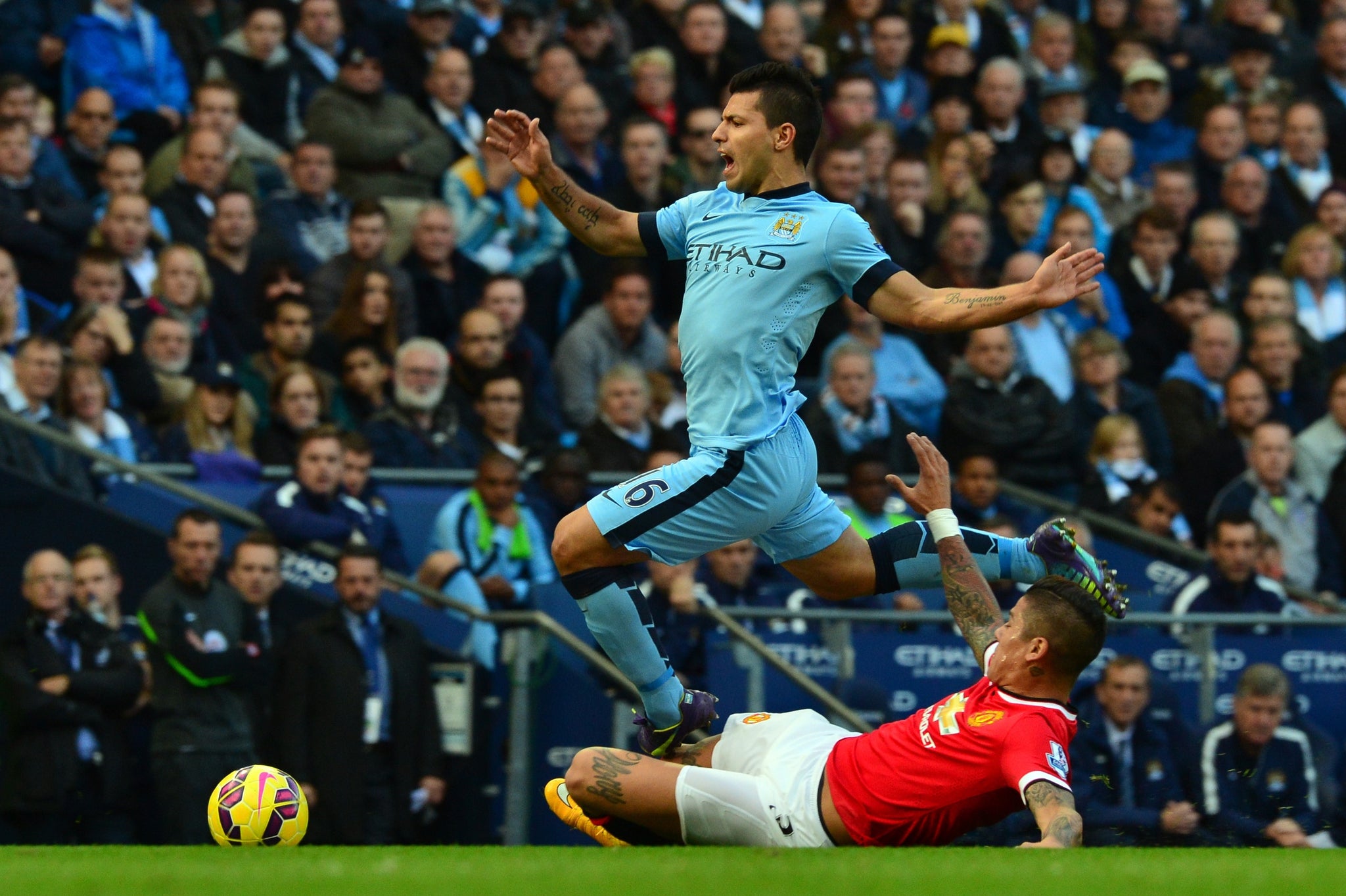 Sergio Aguero skips past Marcos Rojo