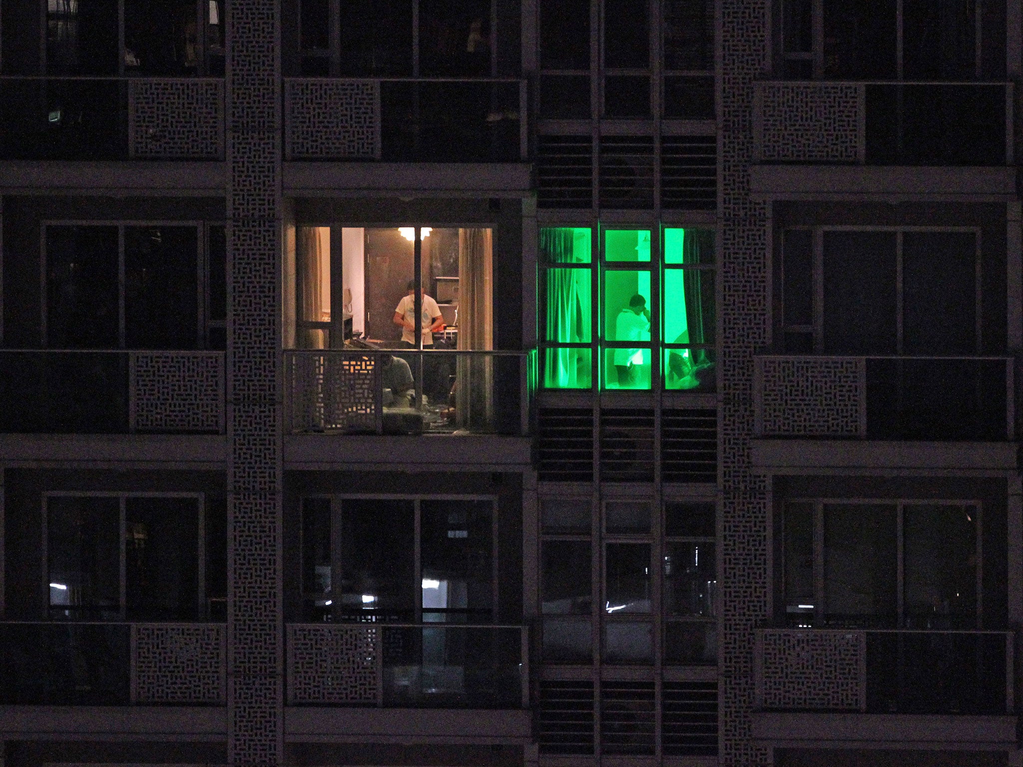 Forensic police working in the Hong Kong flat where the bodies of two women were found