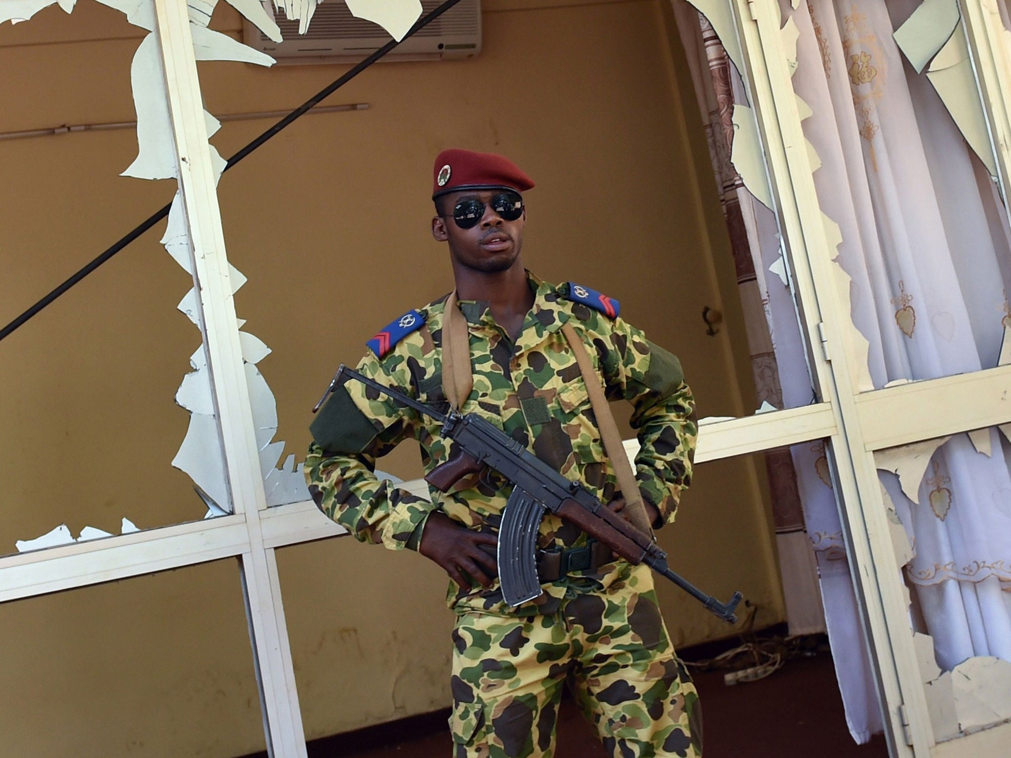 A Burkinese soldier stands guard outside the national television headquarters