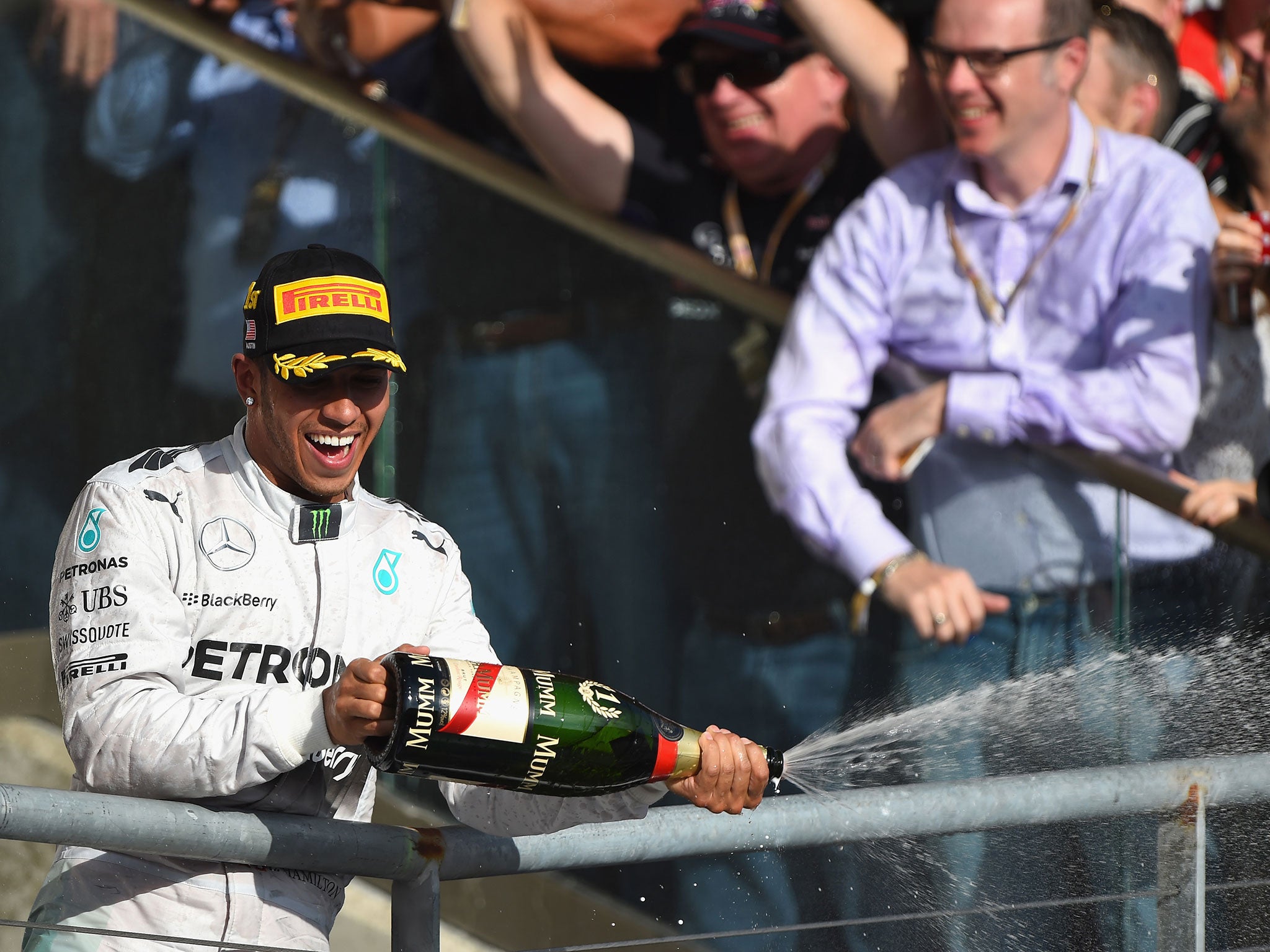 Hamilton celebrates on the podium after his win in Austin