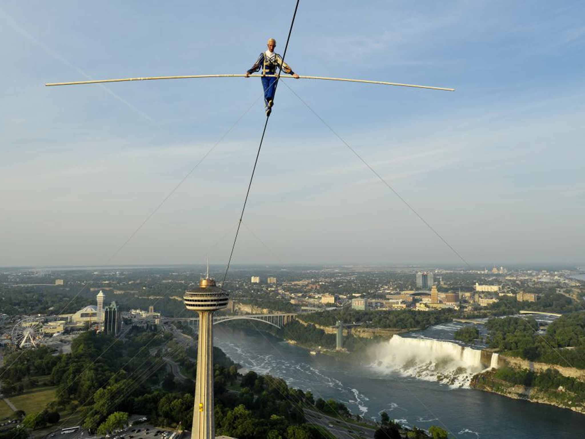 Lofty ambitions: Jay Cochrane walks with Niagara Falls in the background