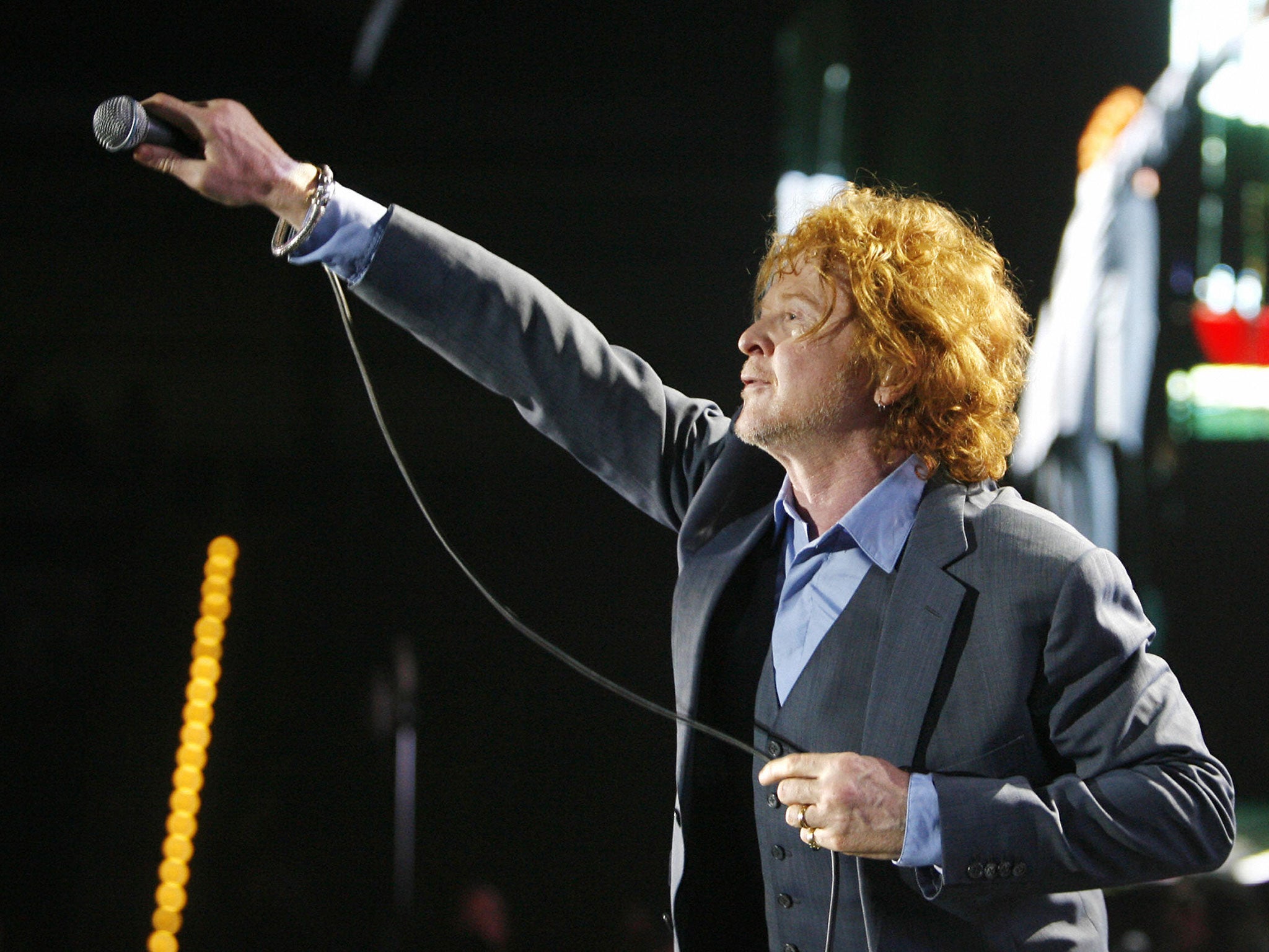 Mick Hucknall, lead singer of the band Simply Red, performing on stage during a concert that was part of their 'last' farewell tour