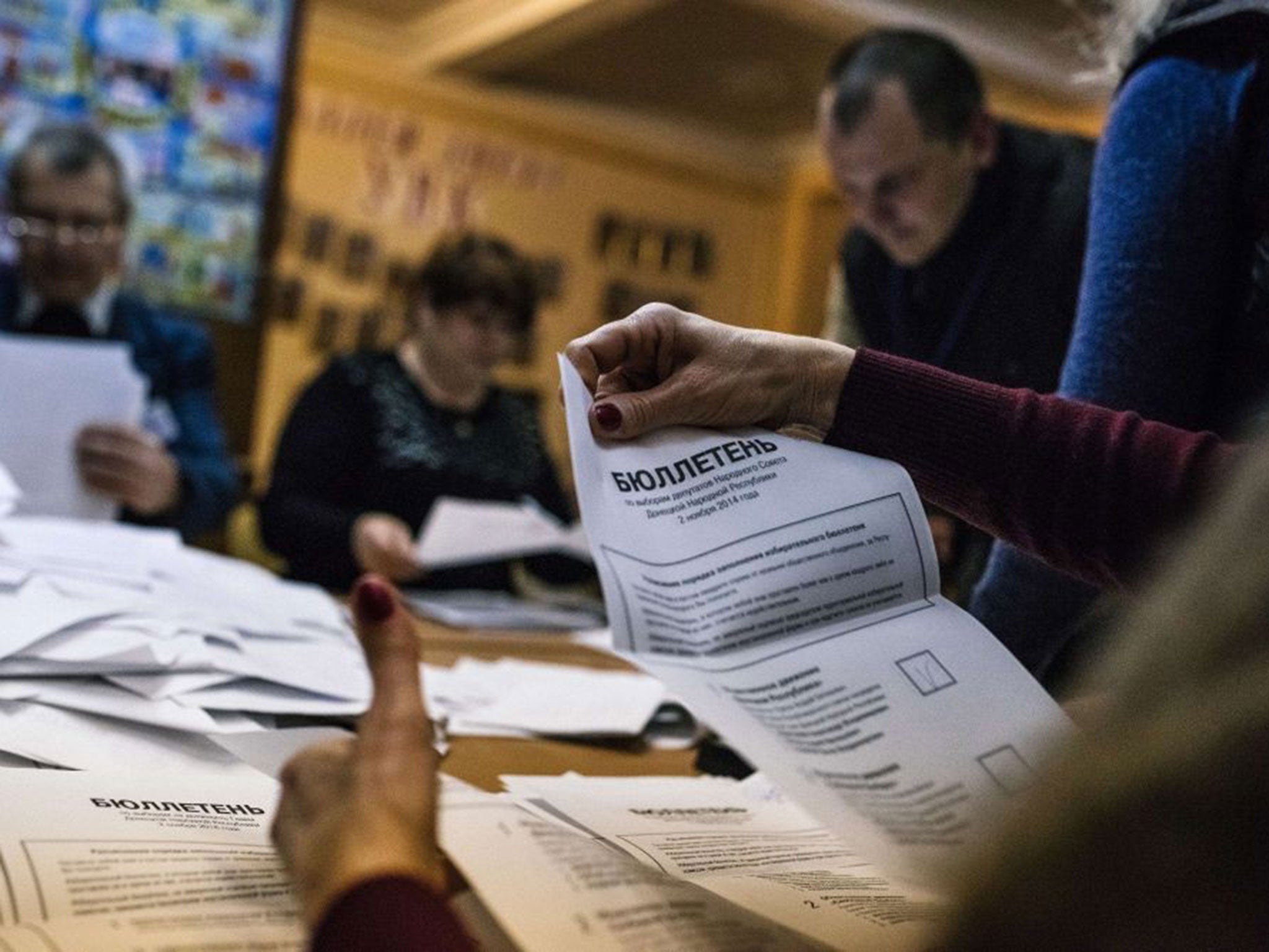 Electoral workers count ballots for the leadership vote in the self-declared Donetsk People's Republic and Luhansk People's Republic