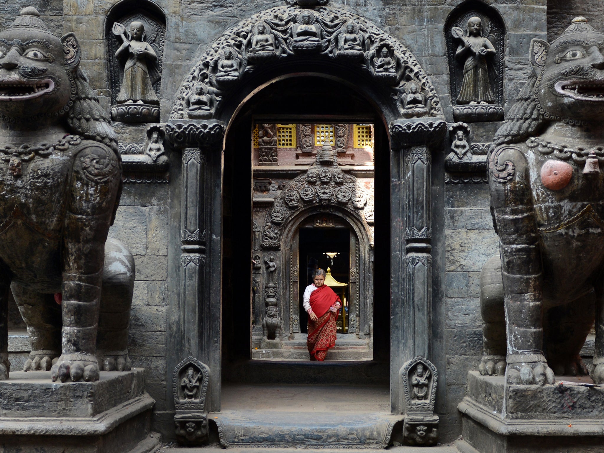 A Nepalese Buddhist devotee leaves the Golden Temple after offering prayers near Patan Durbar square in Lalitpur, about five kilometers south-east of Kathmandu (Photo: AFP/Getty Images)