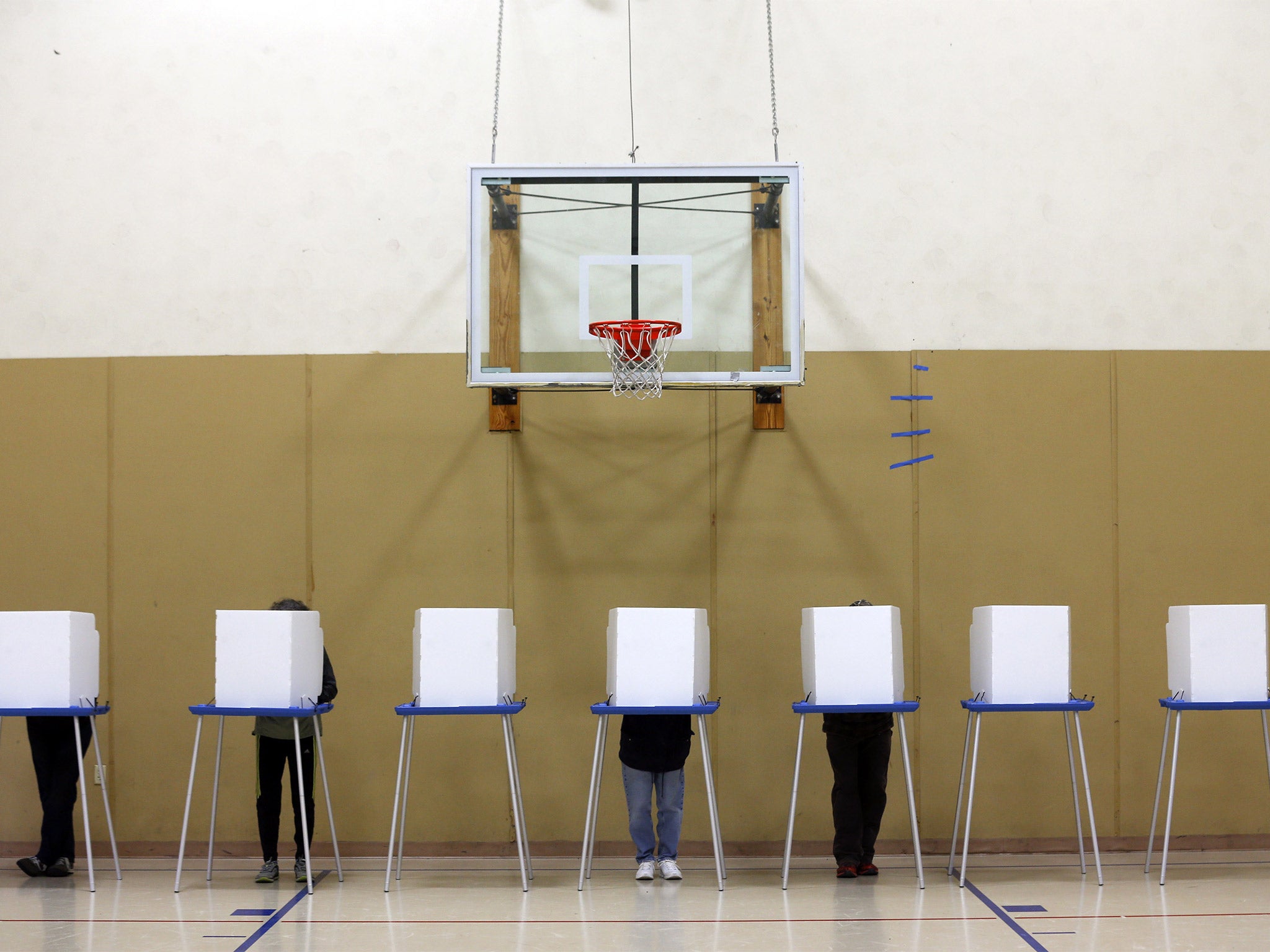 Voters fill out their ballots in a gym on election day in Albany, New York