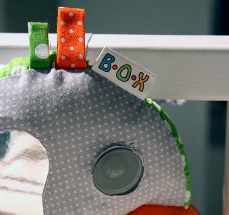 The motion-sensitive camera that hangs on the side of the crib and snaps pictures and video.