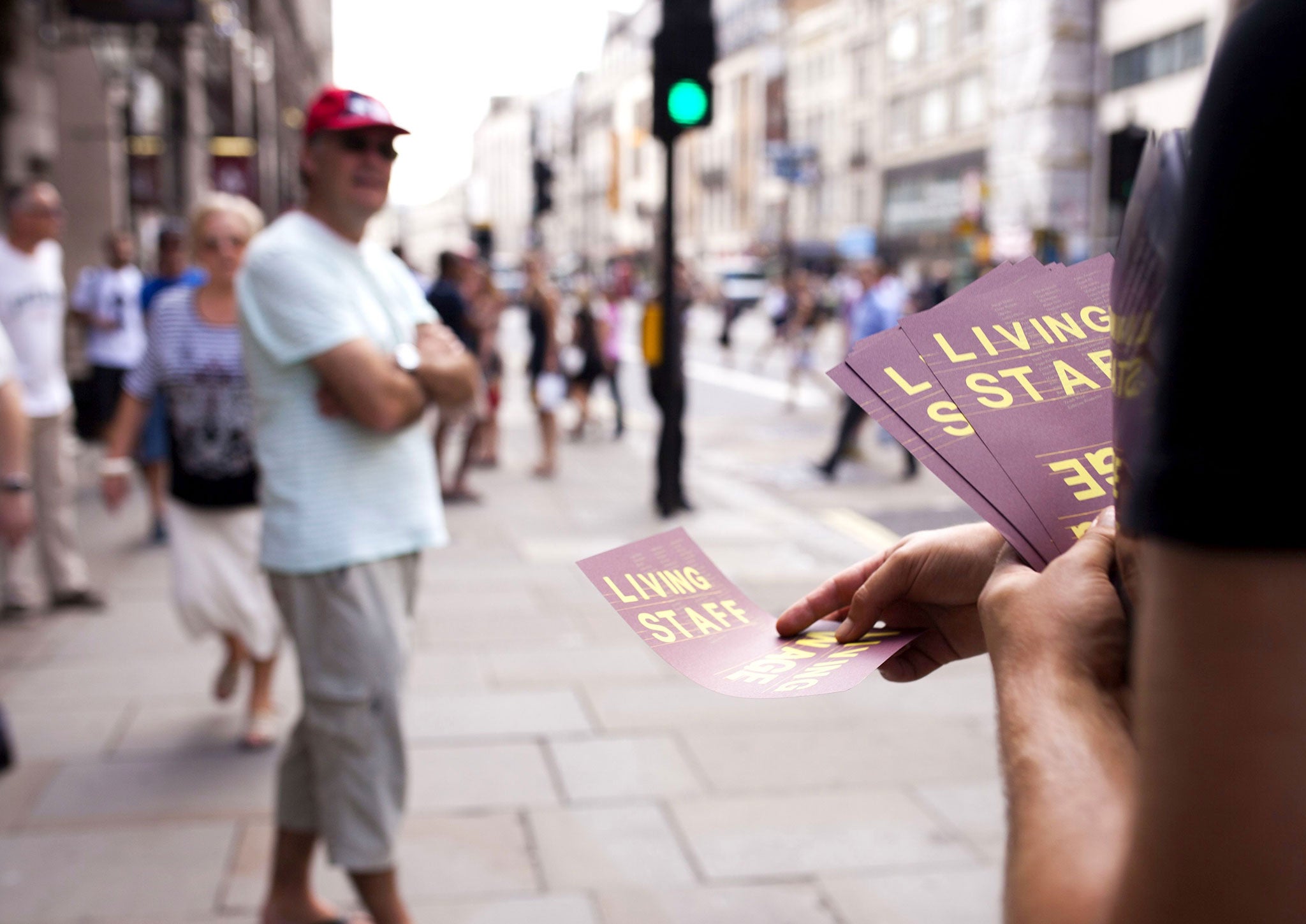 Living Wage leaflets are handed out on a busy street in London