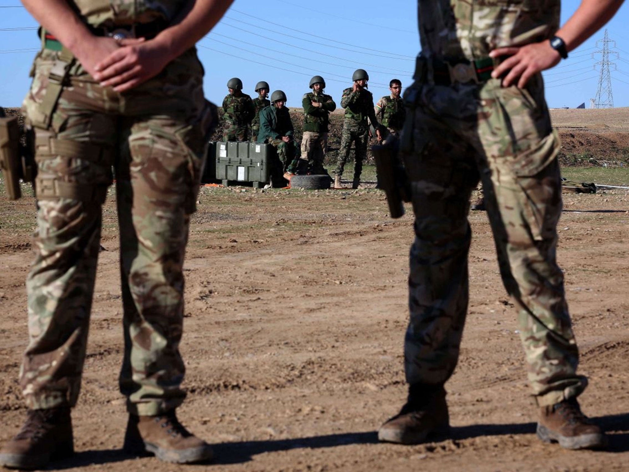 British military advisers instruct Kurdish Peshmerga fighters during a training session at a shooting range in Arbil (AFP)