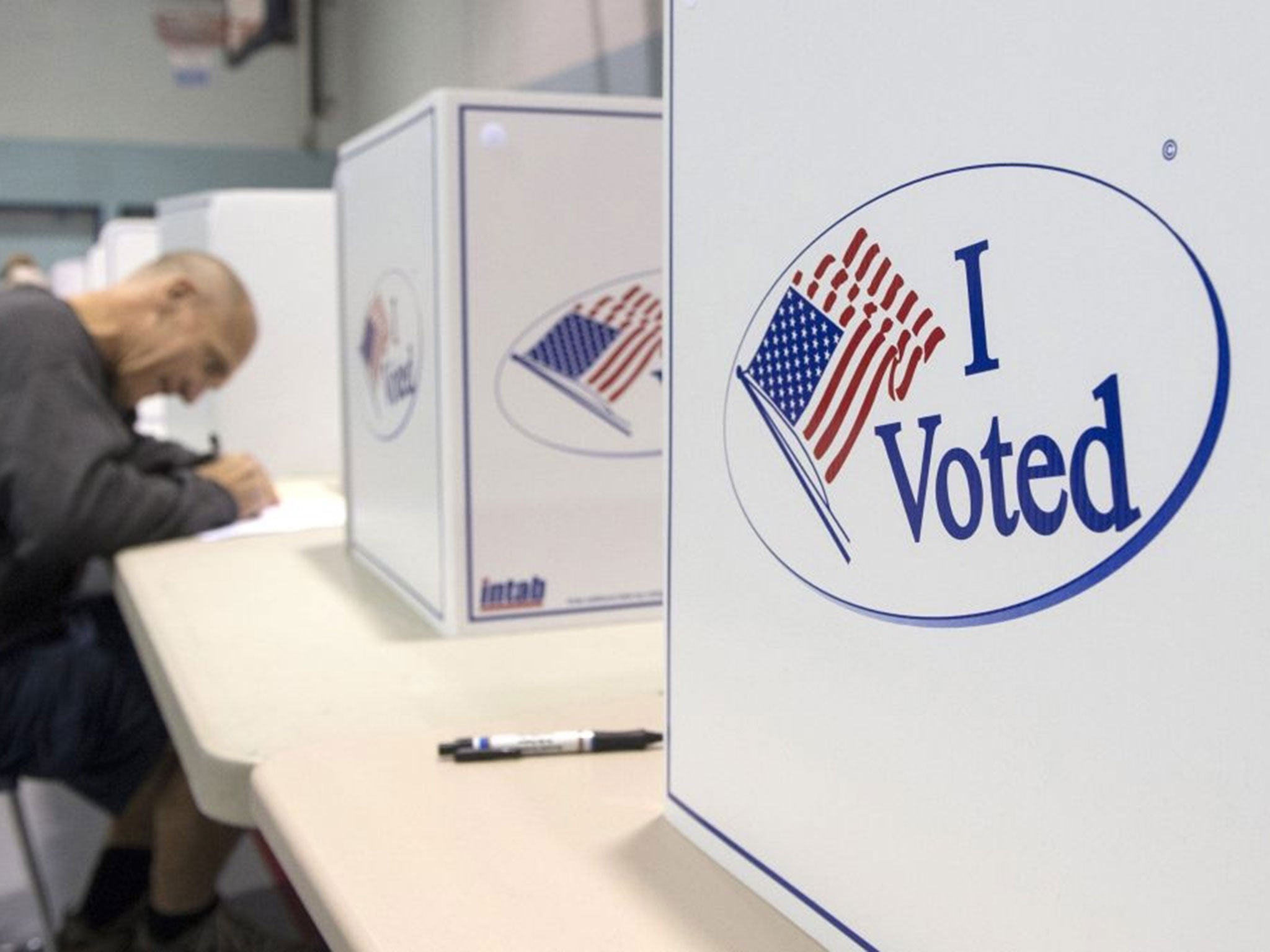 A voter casts a ballot at a polling station in Virginia