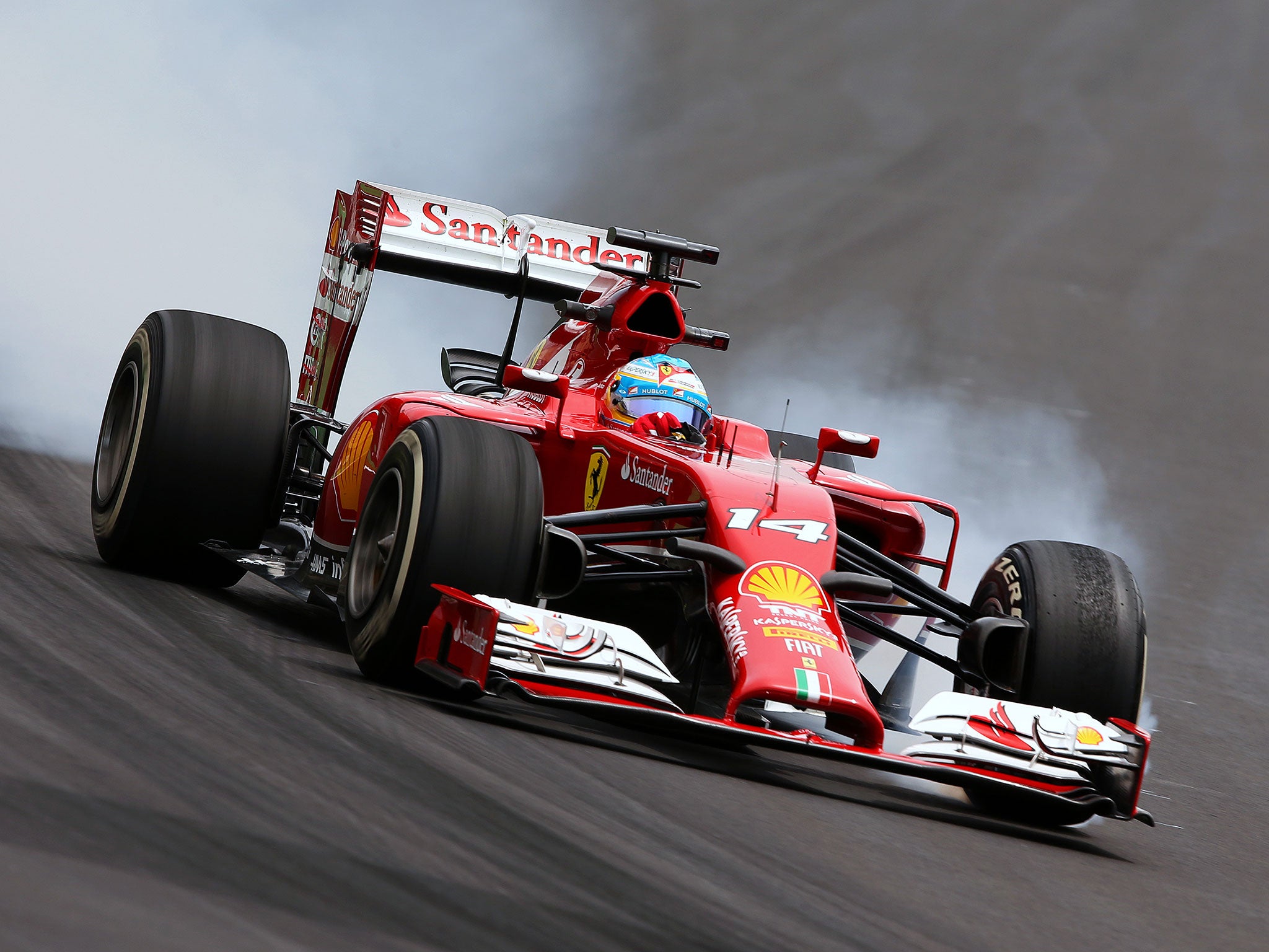 Fernando Alonso locks up heavily as he turns into the first corner