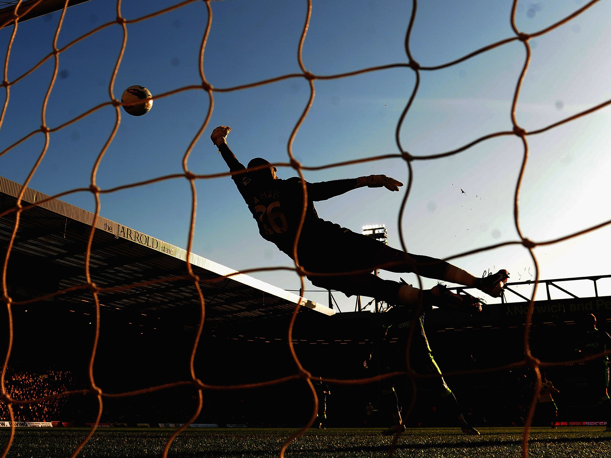 Ali Al Habsi of Wigan Athletic fouls to save a goal during the Barclays Premier League match between Norwich City and Wigan Athletic at Carrow Road