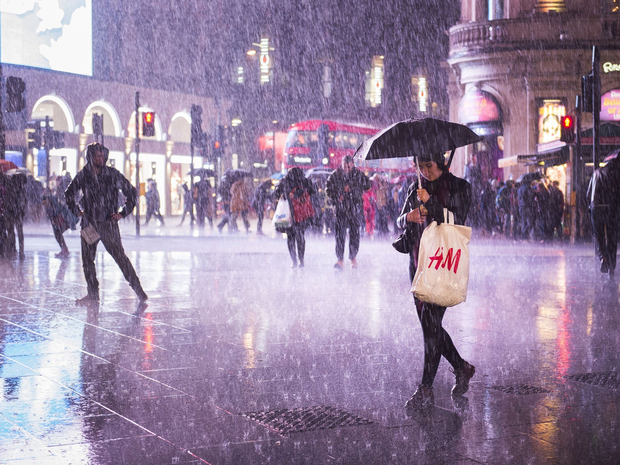 Heavy rain sweeps over Piccadilly Circus in London