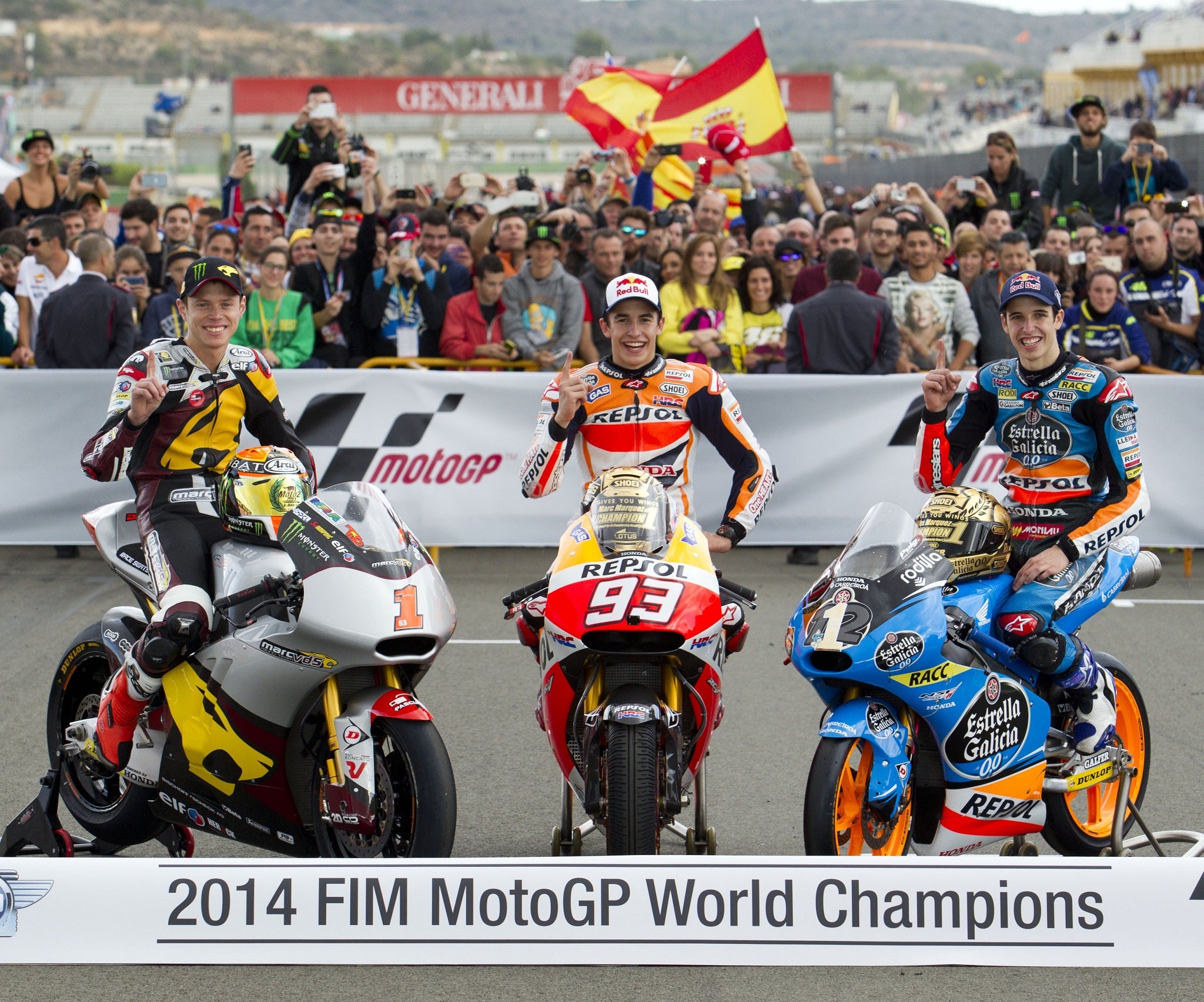 World Champions, Moto GP Repsol Honda's Marc Marquez (C), Moto 2 Marc VDS Racing Team's Esteve (Tito) Rabat (L) and Moto 3 Estrella Galicia 0,0's Alex Marquez