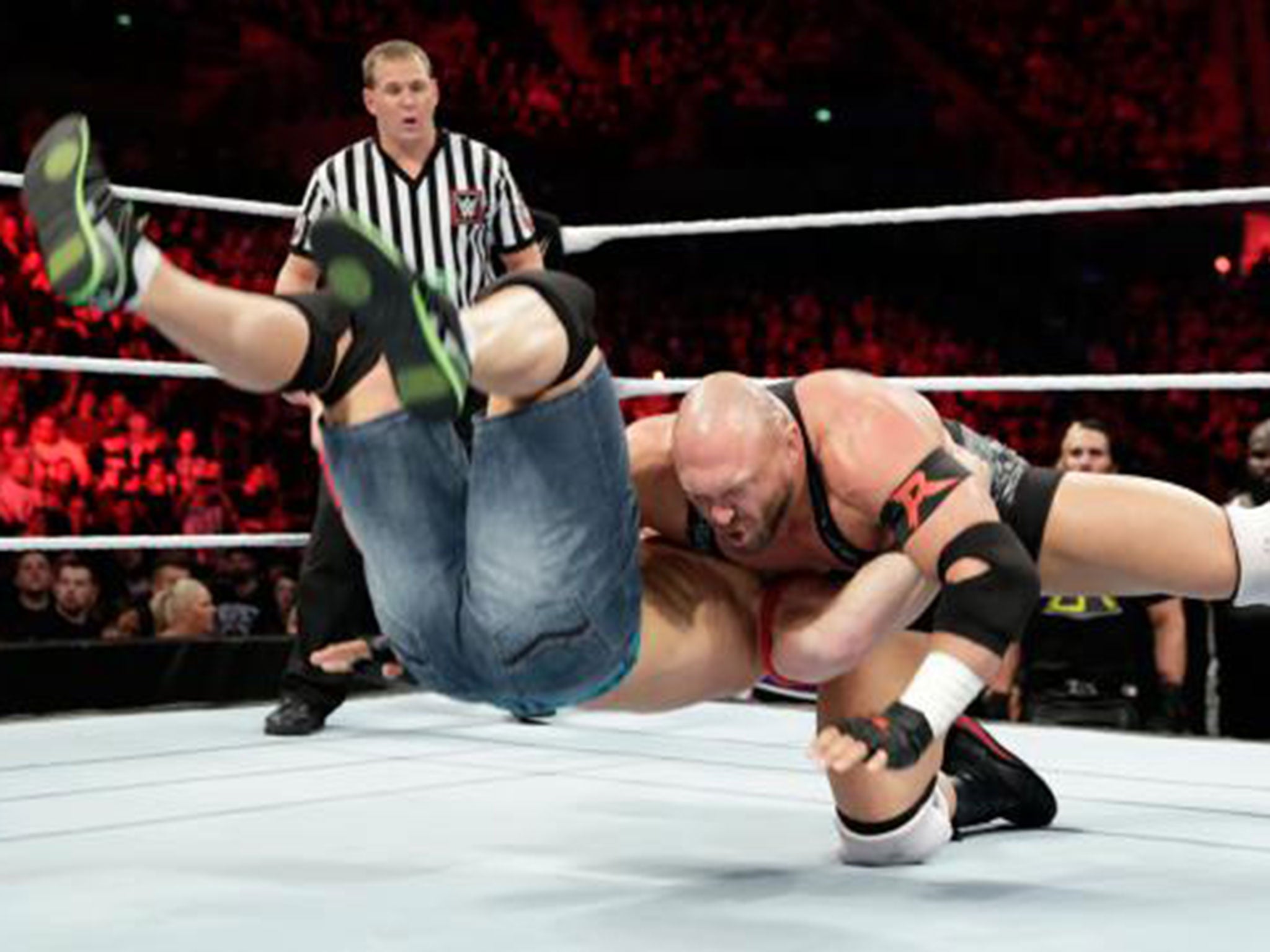 Ryback slams John Cena into the canvas during their main event clash