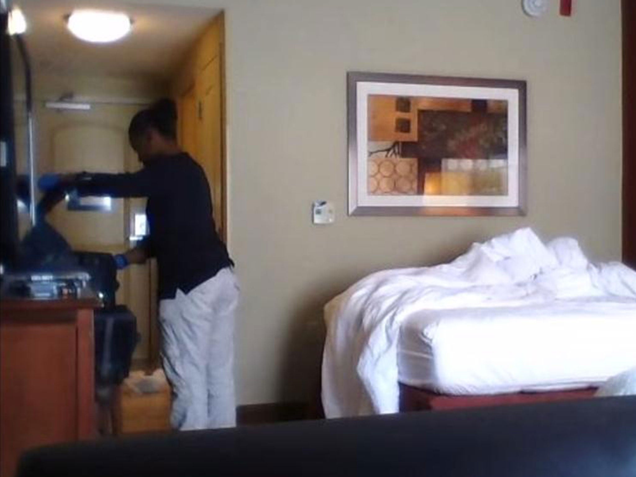 The cleaner appears to rifle through luggage