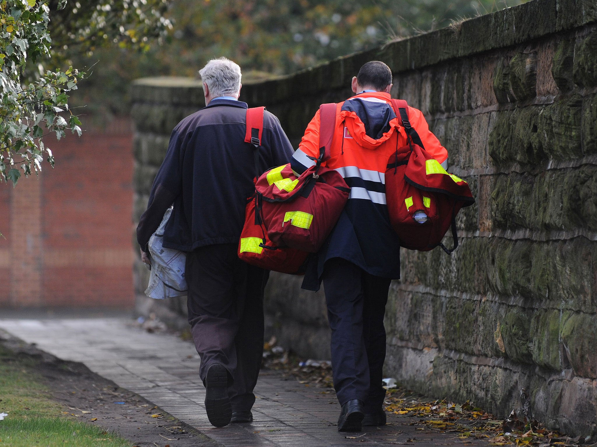 Postmen carry sacks of mail in Liverpool