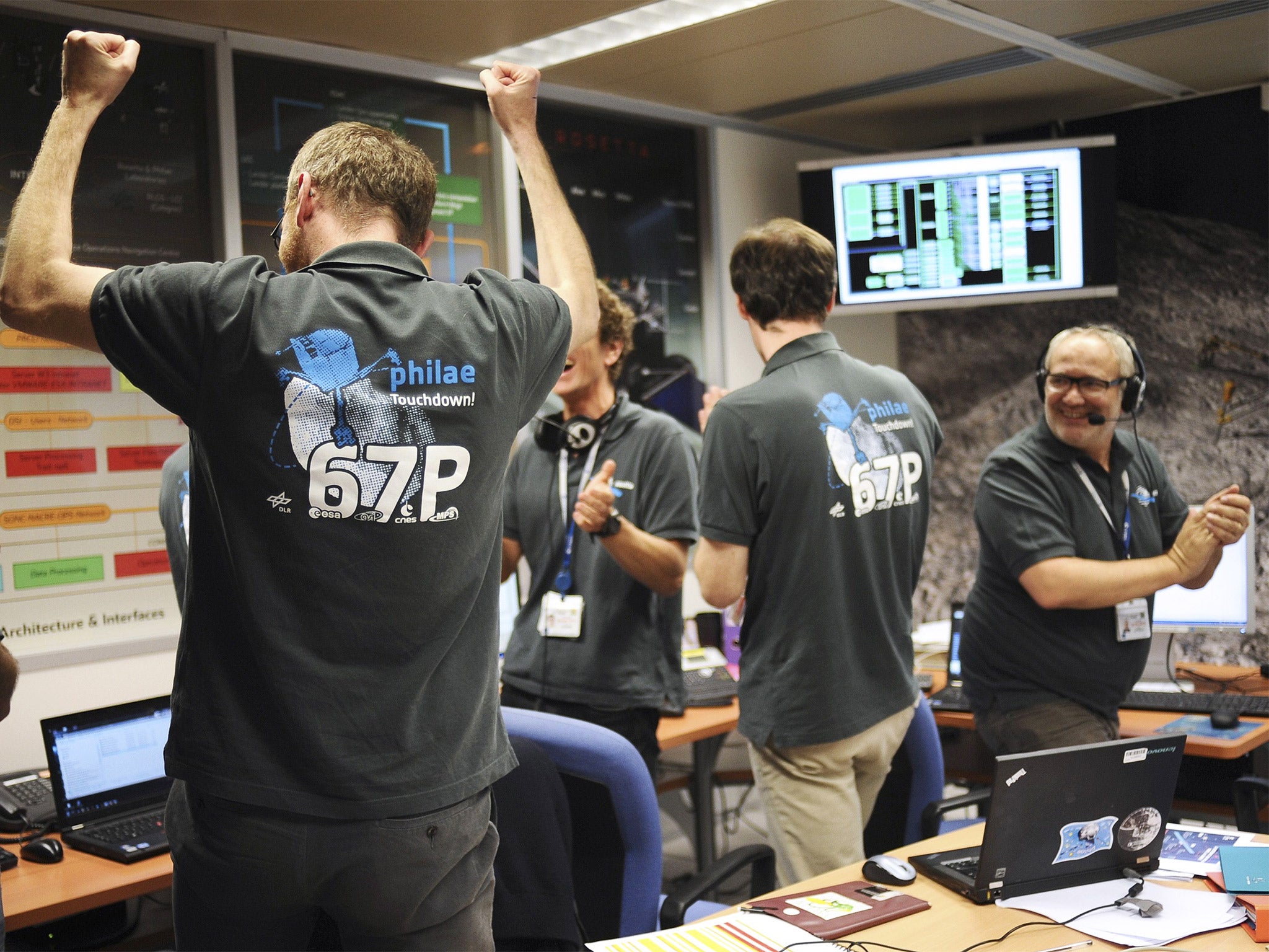 Scientists celebrate at a mission observation centre in Toulouse, southern France as they receive information that Philae has landed on the Churyumov-Gerasimenko comet