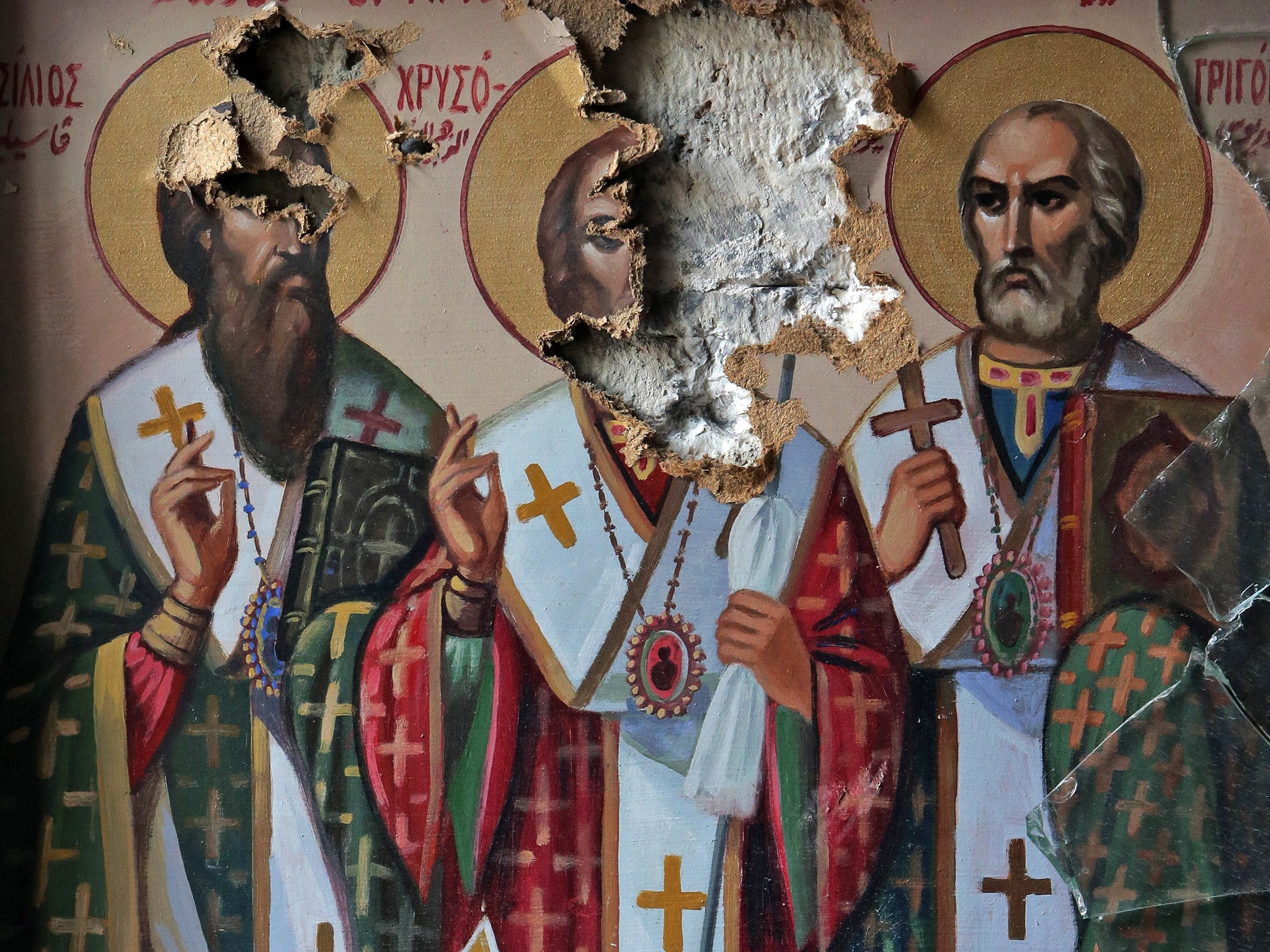 Damaged icons inside the church of the monastery of Saint Takla in the ancient Christian town of Maalula, 56km from Damascus (Getty)