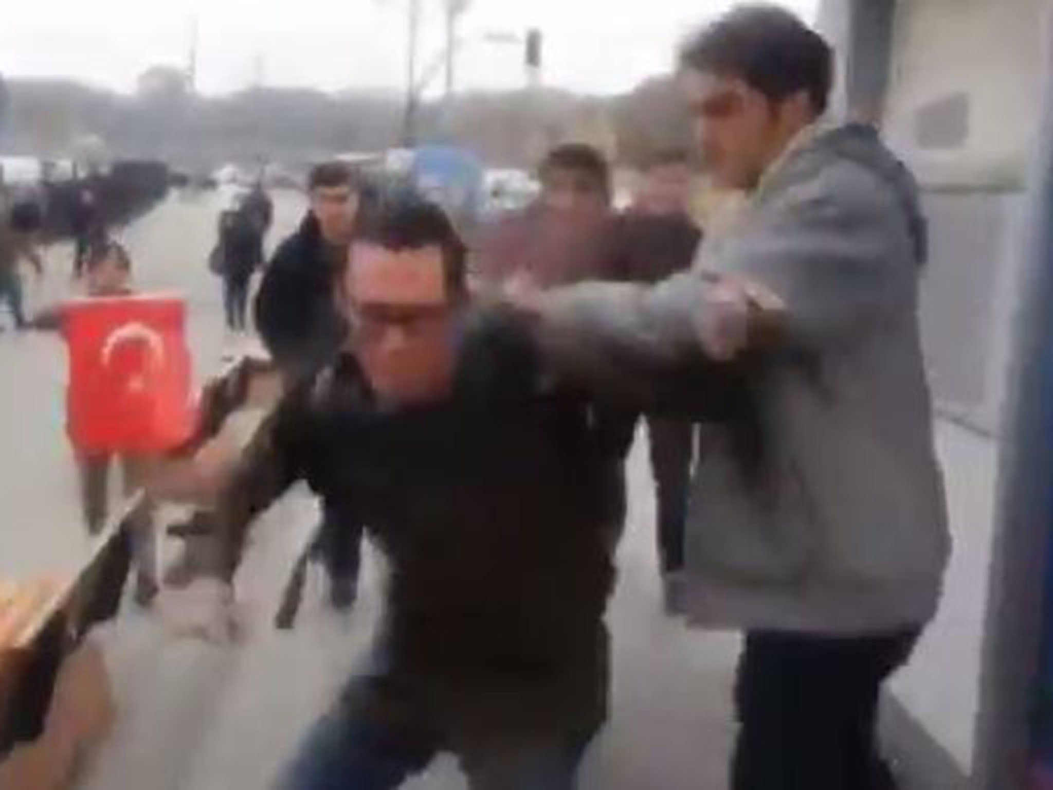 The footage shows members of the group, who were carrying a banner of the left-leaning Youth Association of Turkey, throwing red paint at the sailors, while another calls them "killers"