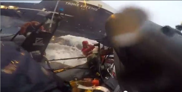 A Greenpeace activist attempting to reboard the dinghy