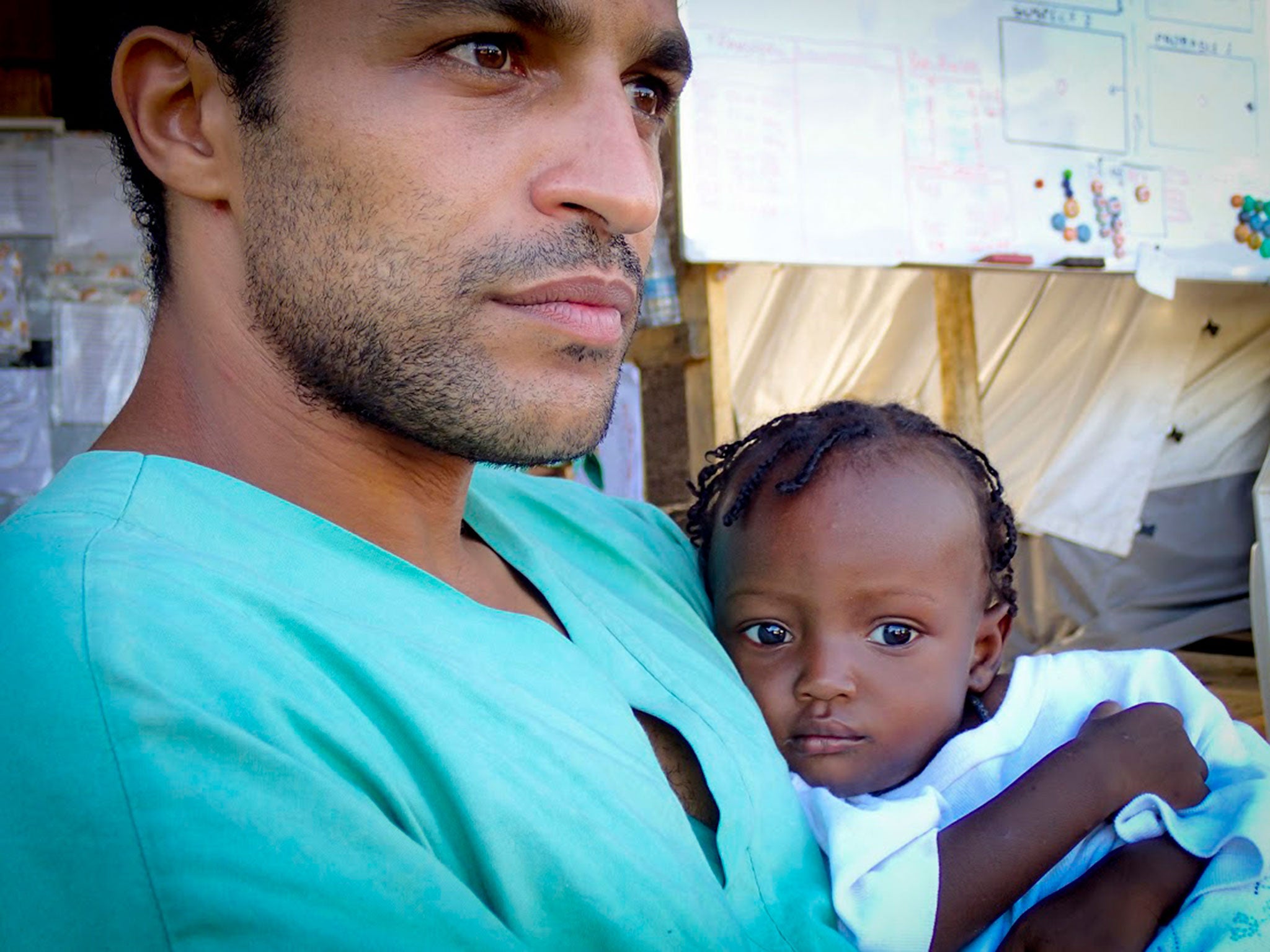 The author with a baby called Warrah in Sierra Leone. Helping those with the disease recover from it brought about a feeling of elation on his return to Britain – but it did not last long