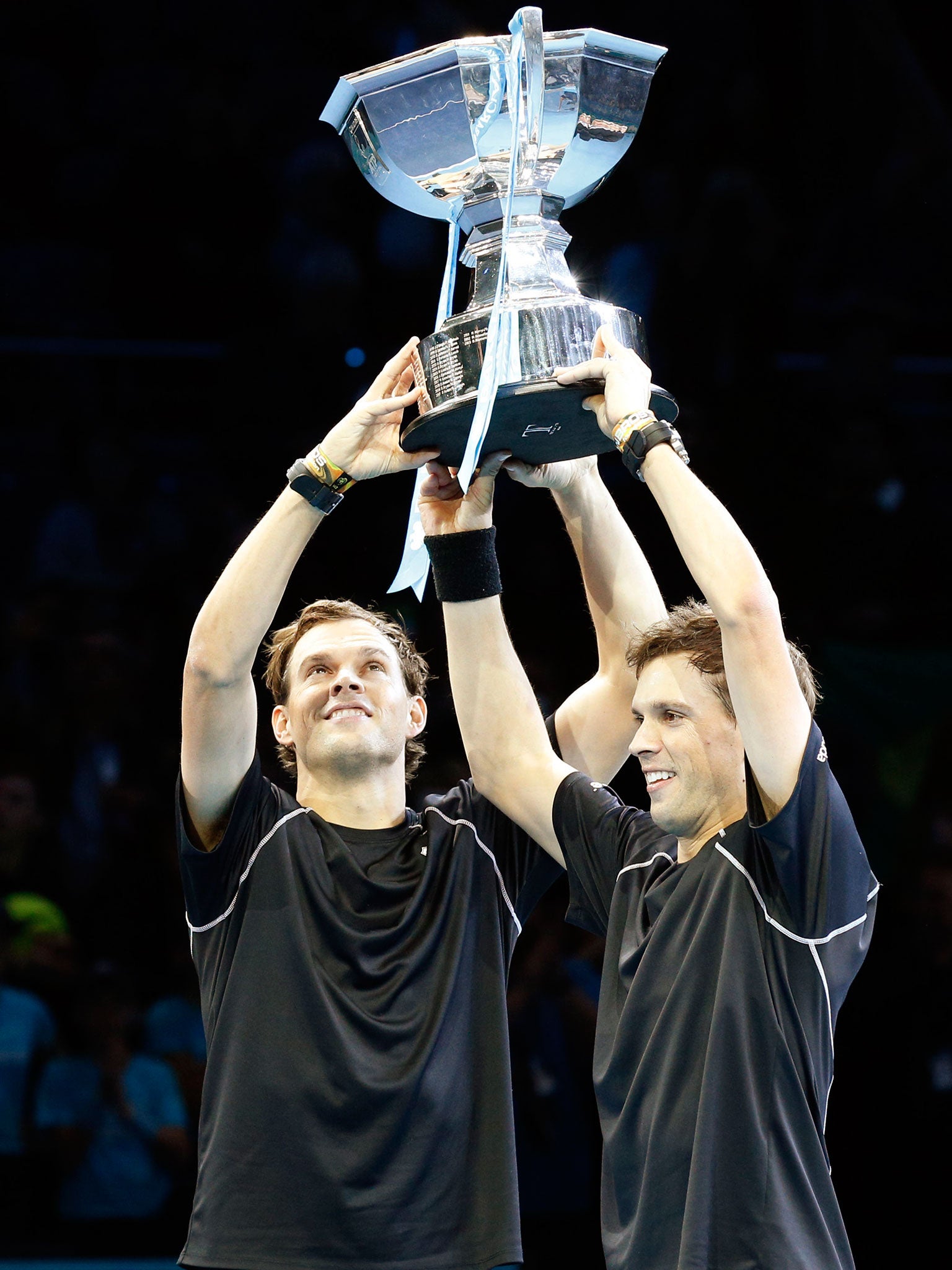 Bryan brothers Bob and Mike hold the doubles trophy aloft