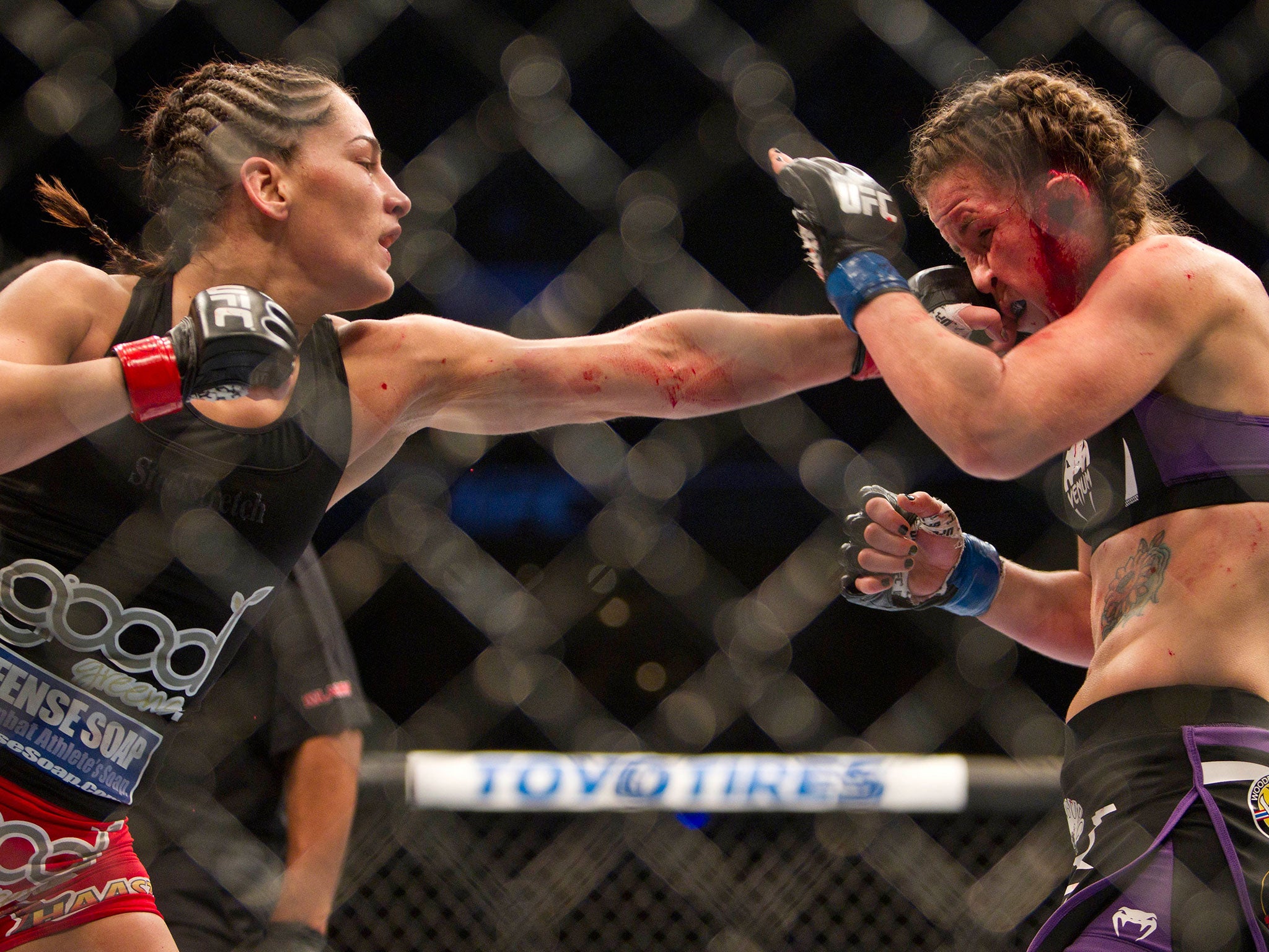 Jessica Eye lands a left hand on Leslie Smith