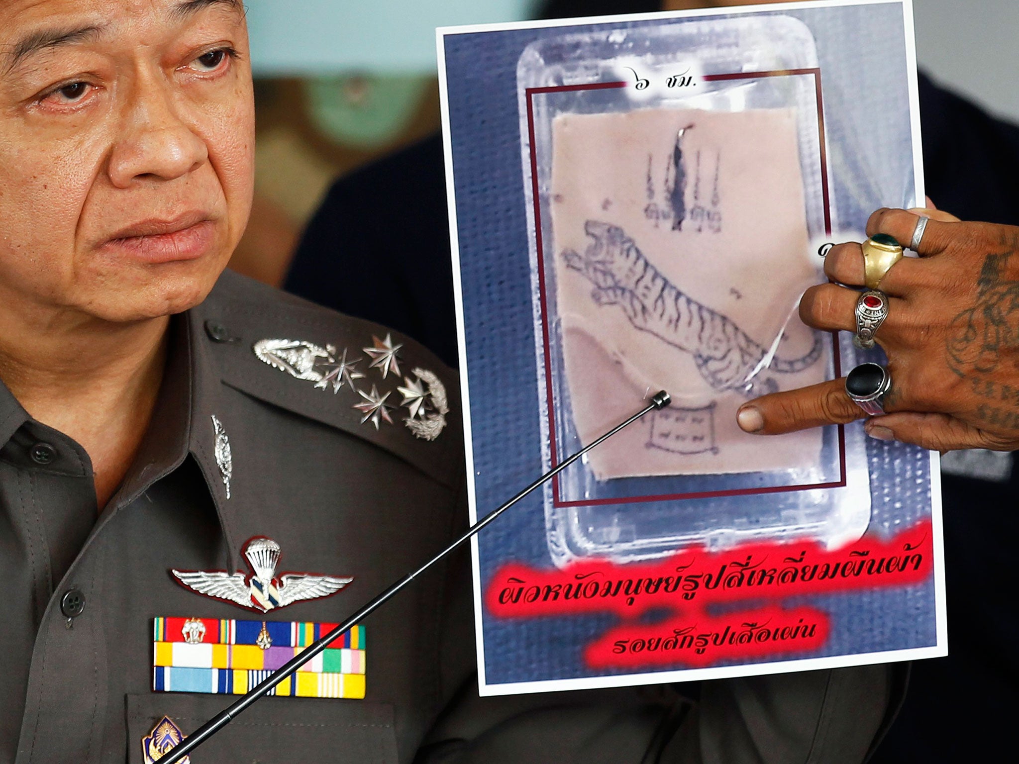 An officer with a photograph of one of the parts