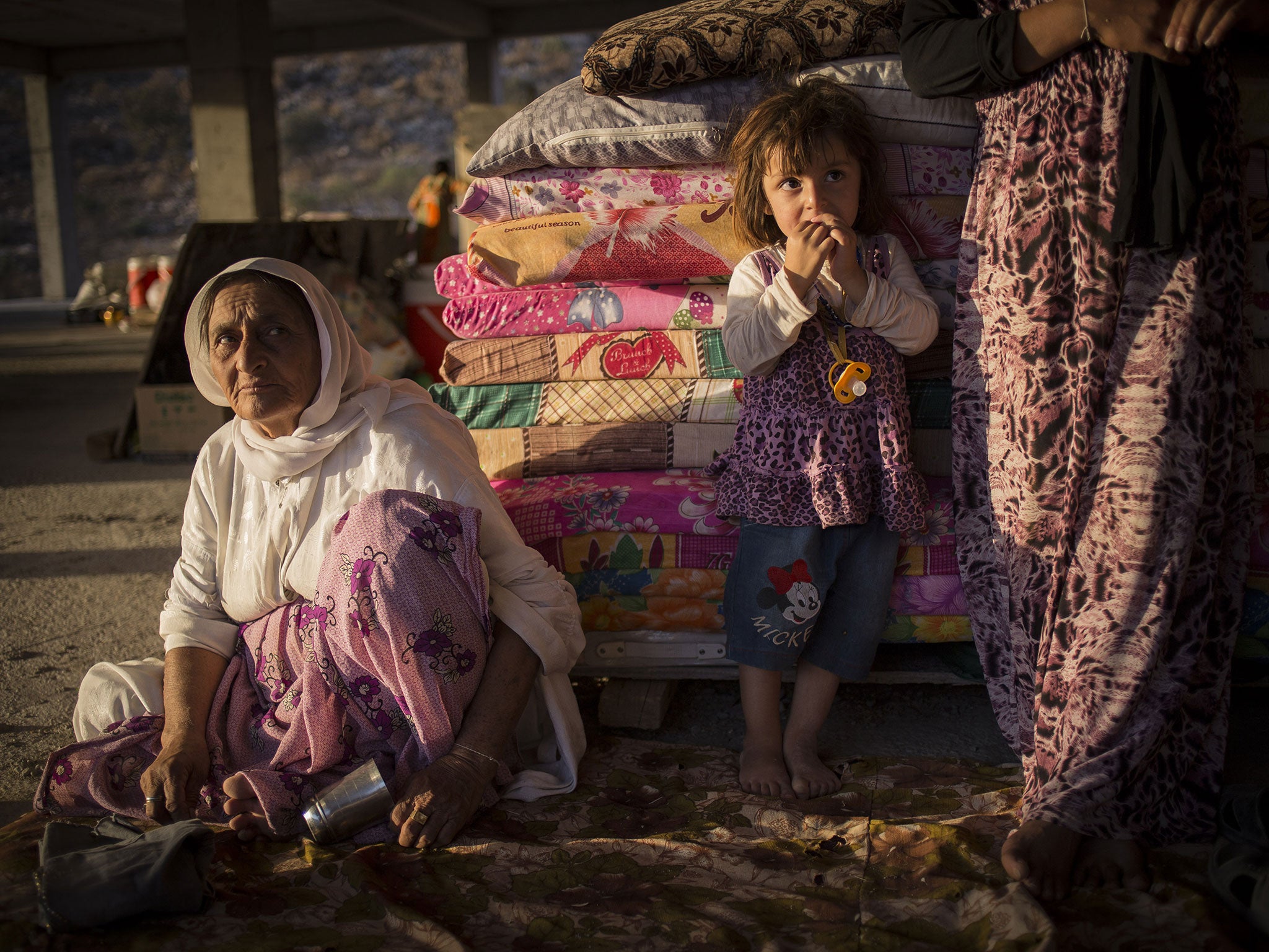 In an almost biblical scene displaced people from the minority Yazidi sect fleeing Isis fighters make their way towards the Syrian border, on the outskirts of Mount Sinjar