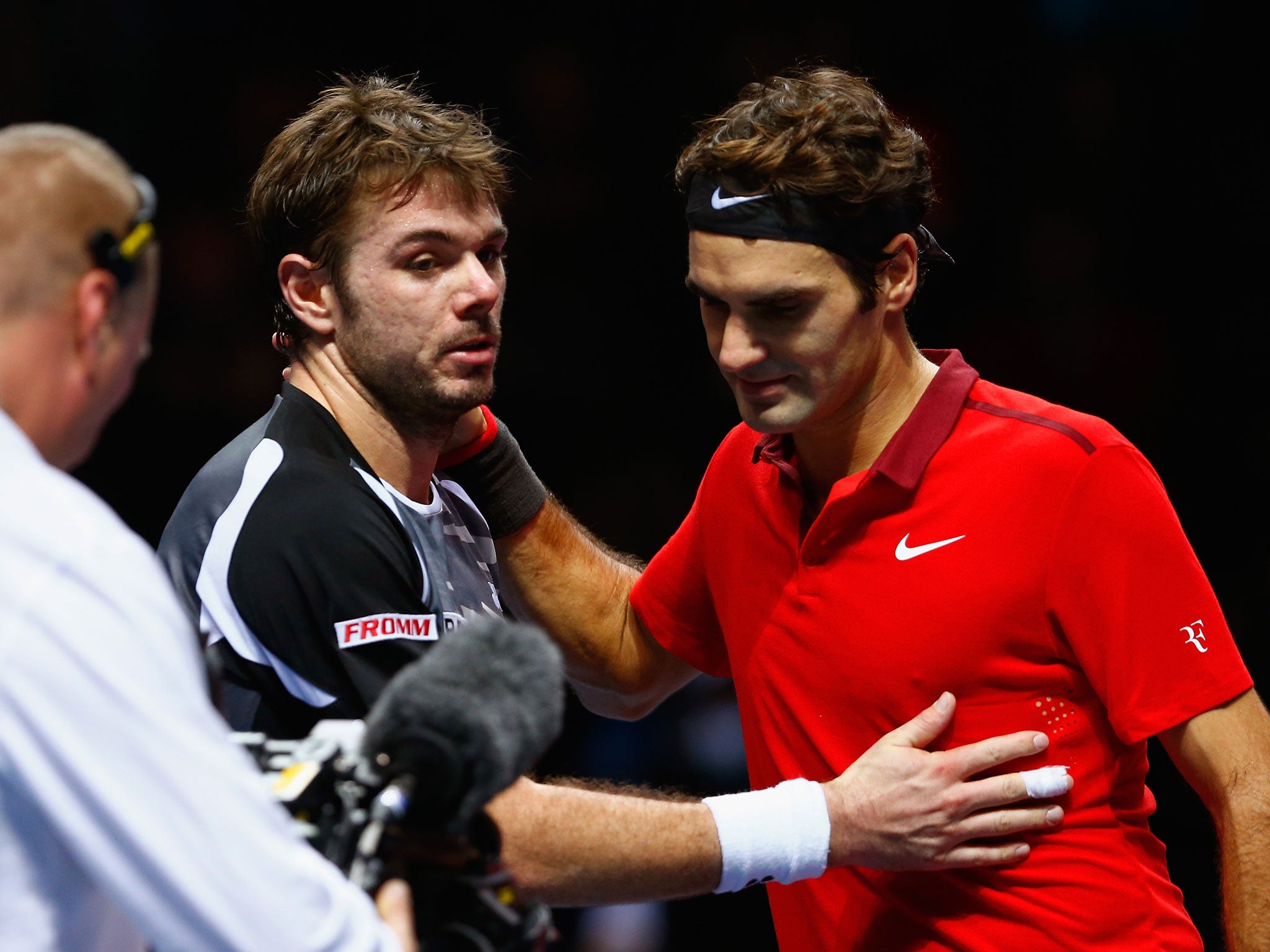 Stan Wawrinka and Roger Federer, right, at the net straight after their three-set semi-final at the O2 Arena in London, when Federer won after saving four match points