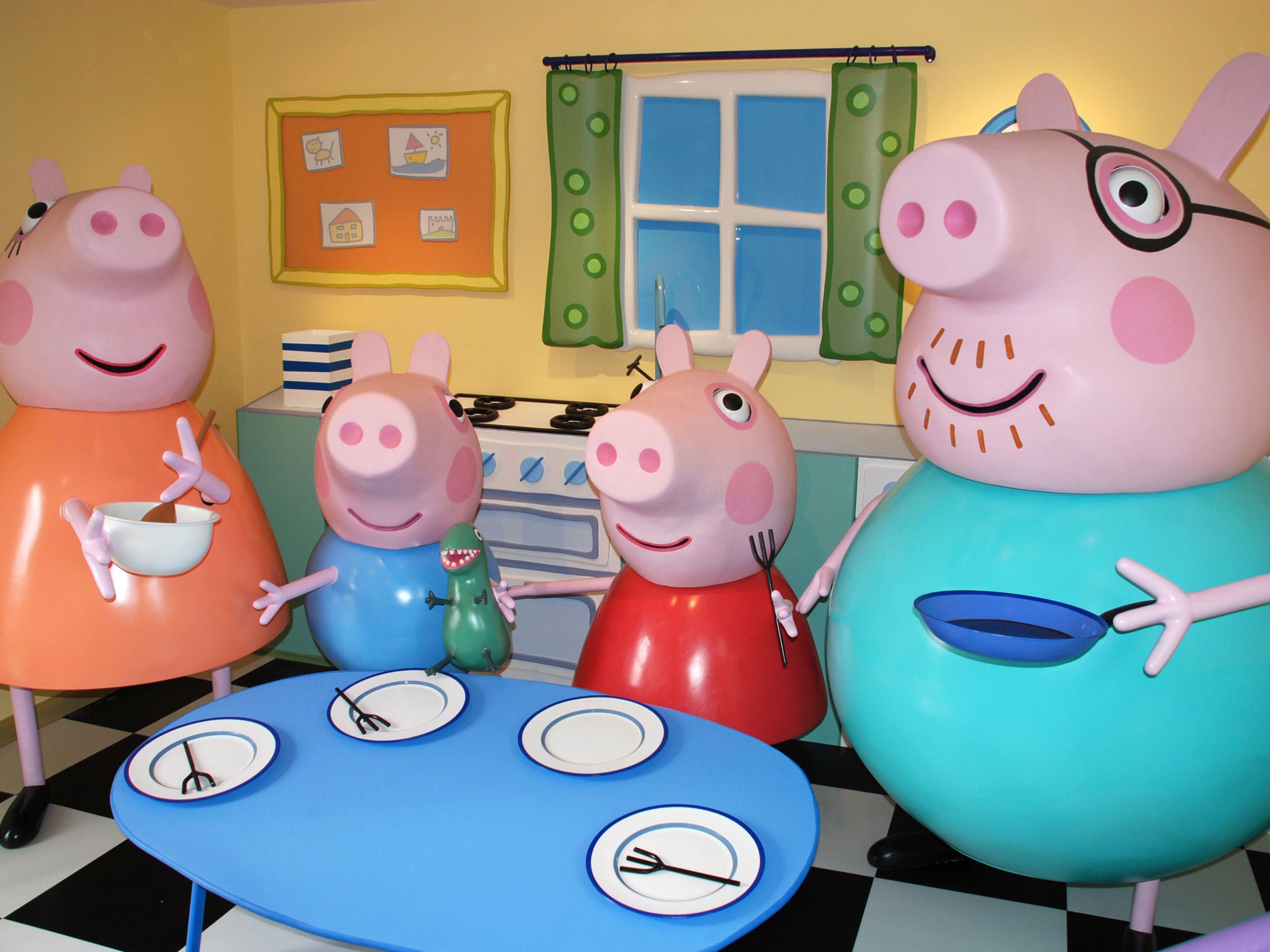 Mummy Pig, George, Peppa Pig and Daddy Pig in Peppa Pig's house.