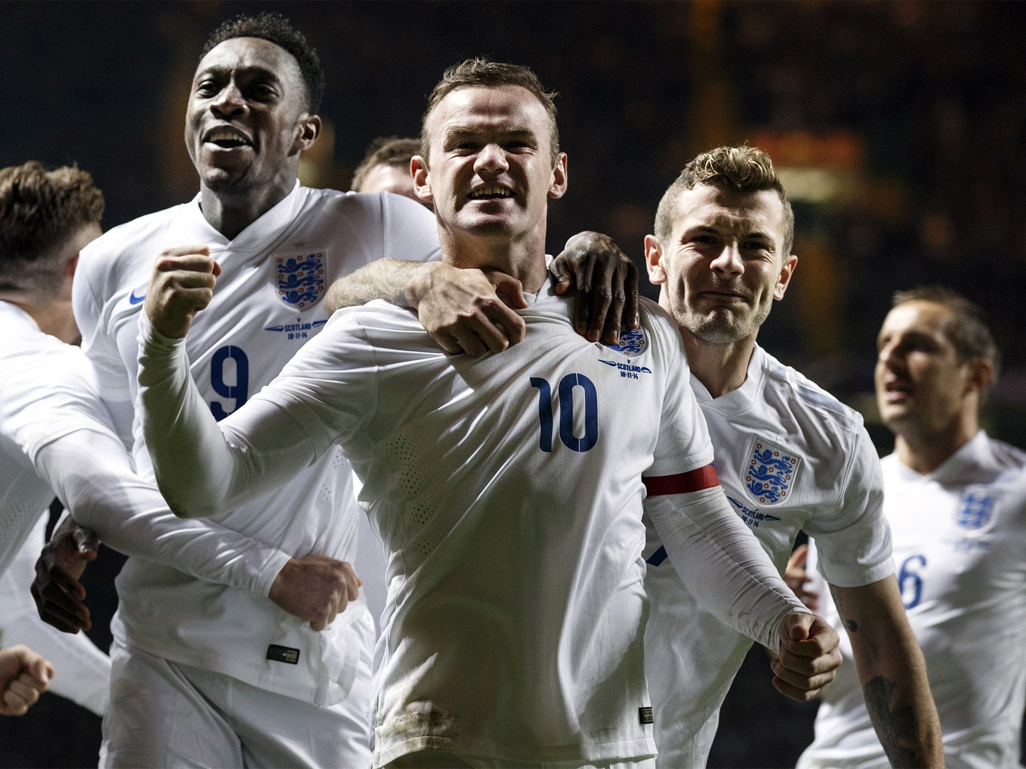 Wayne Rooney (centre) celebrates his first goal against Scotland