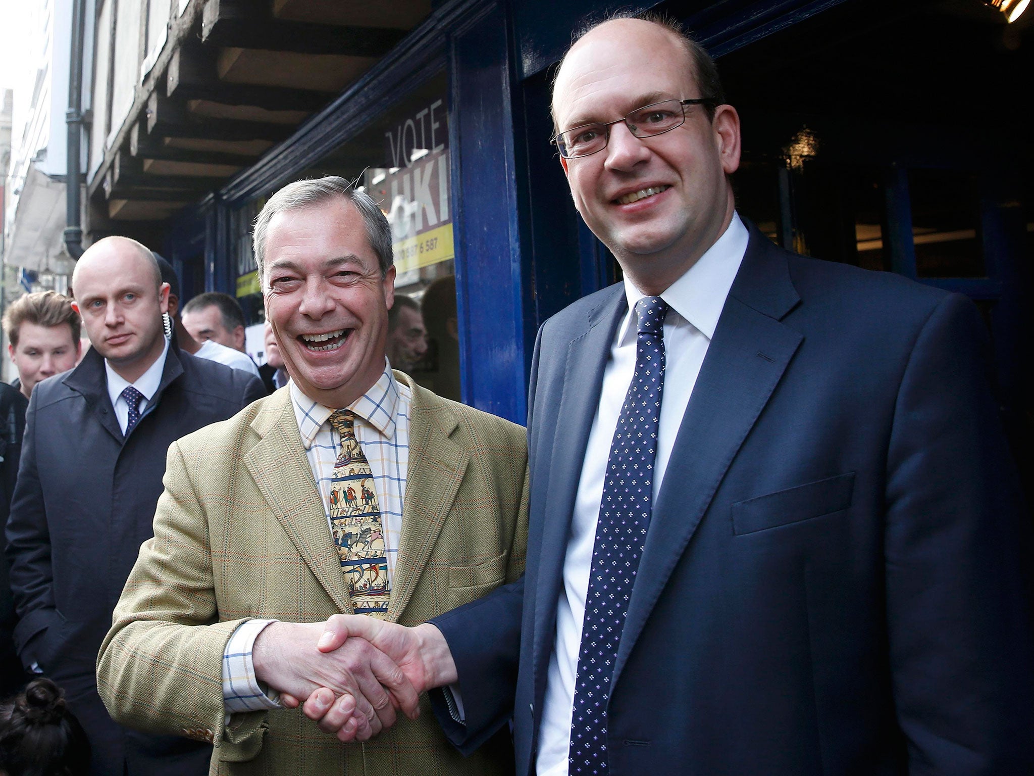 Nigel Farage shakes hands with Mark Reckless, the former Conservative Party member of Parliament for Rochester and Strood, on polling day