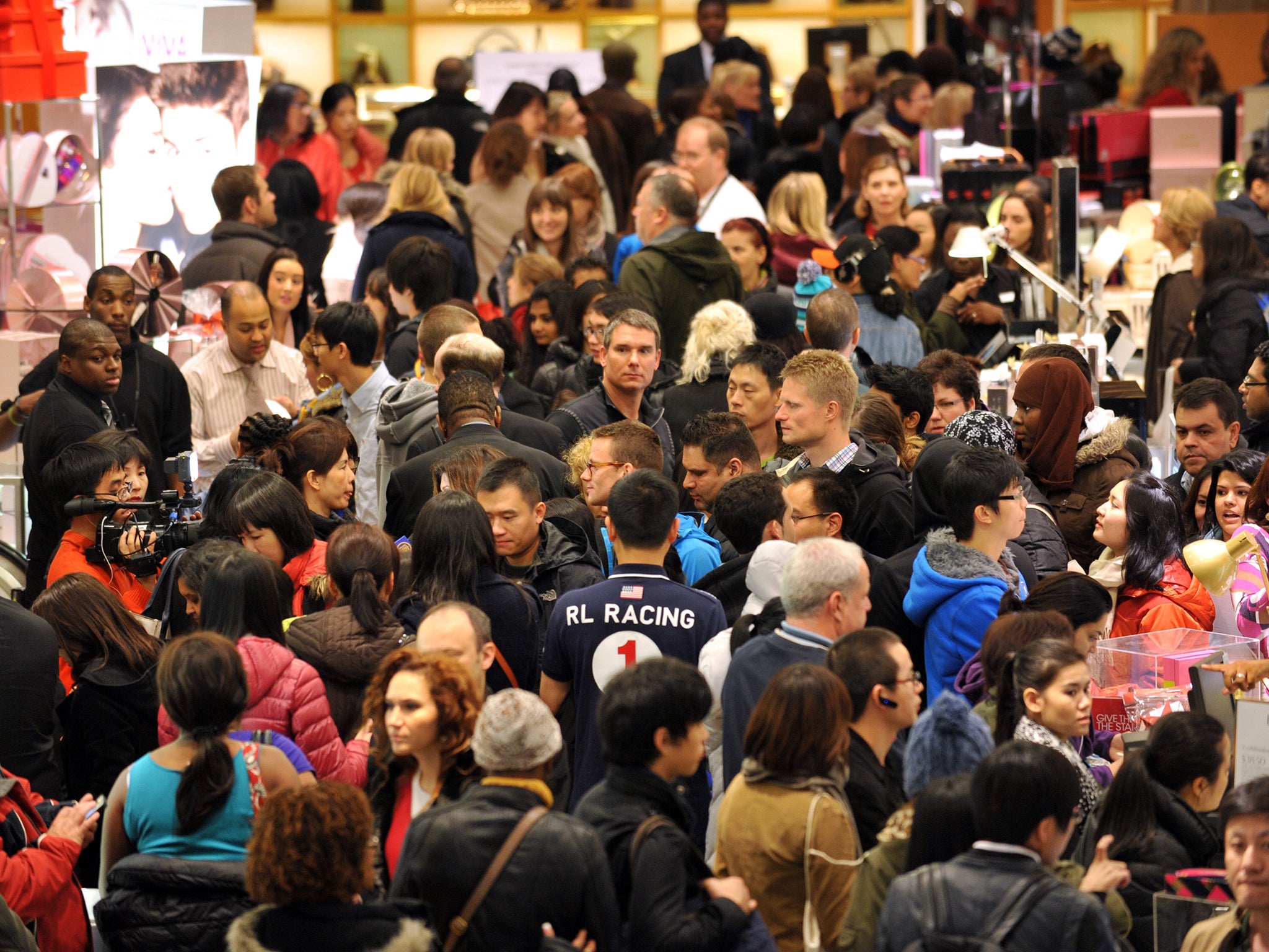 People crowd the first floor of Macy's department store as they open at midnight (0500 GMT) on November 23, 2012 in New York to start the stores' 'Black Friday' shopping weekend.