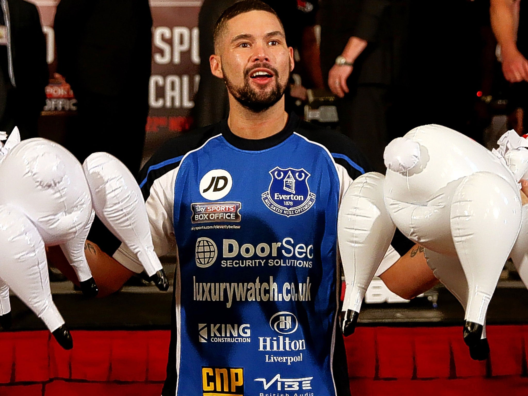 Bellew holds two inflatable plastic sheep at the weigh-in