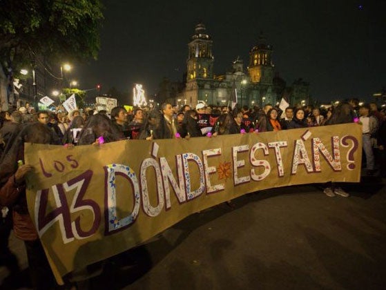 Protesters hold a banner that reads in Spanish "Where are the 43?"