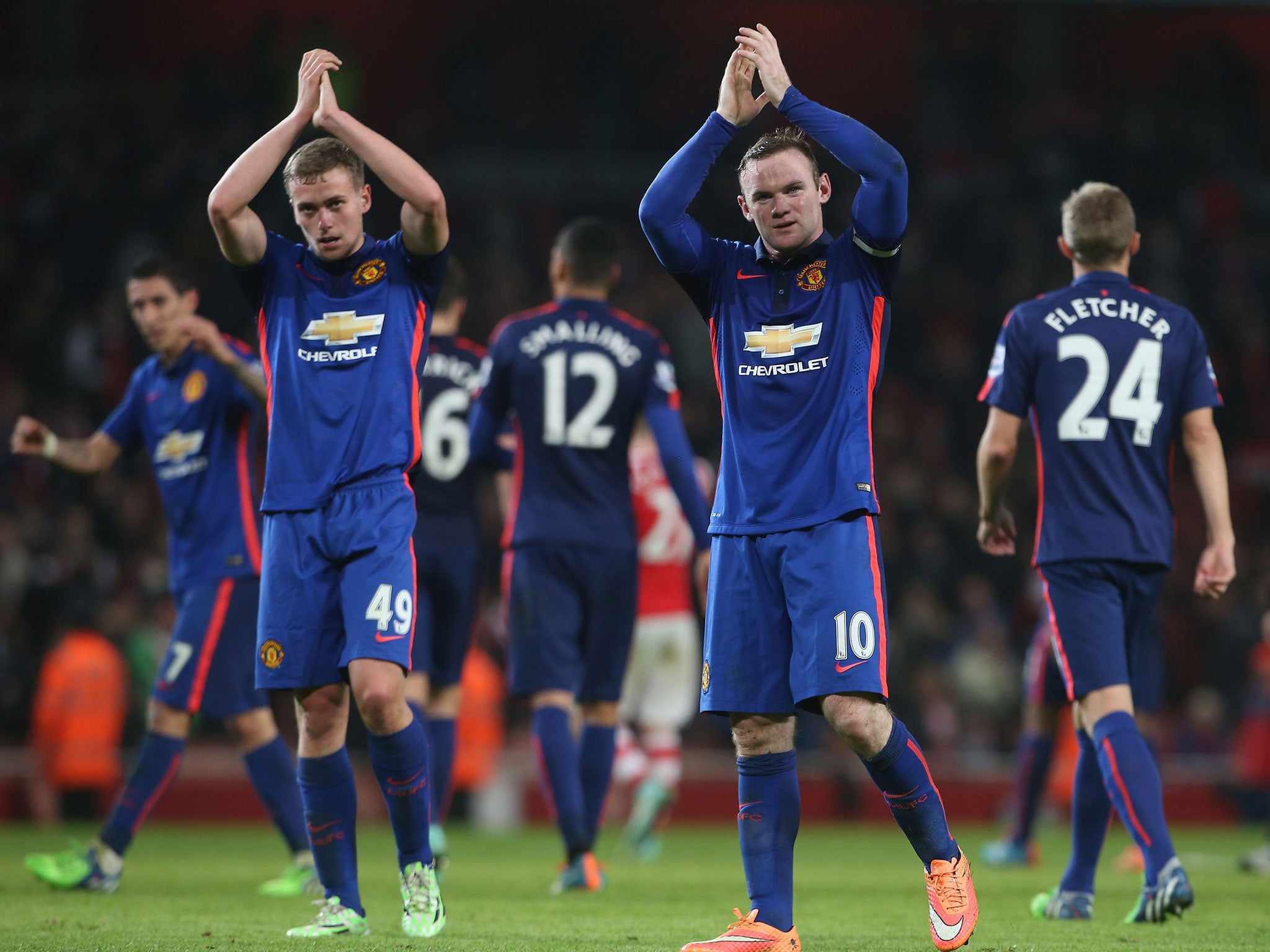 Wayne Rooney and James Wilson applaud the travelling Manchester United fans