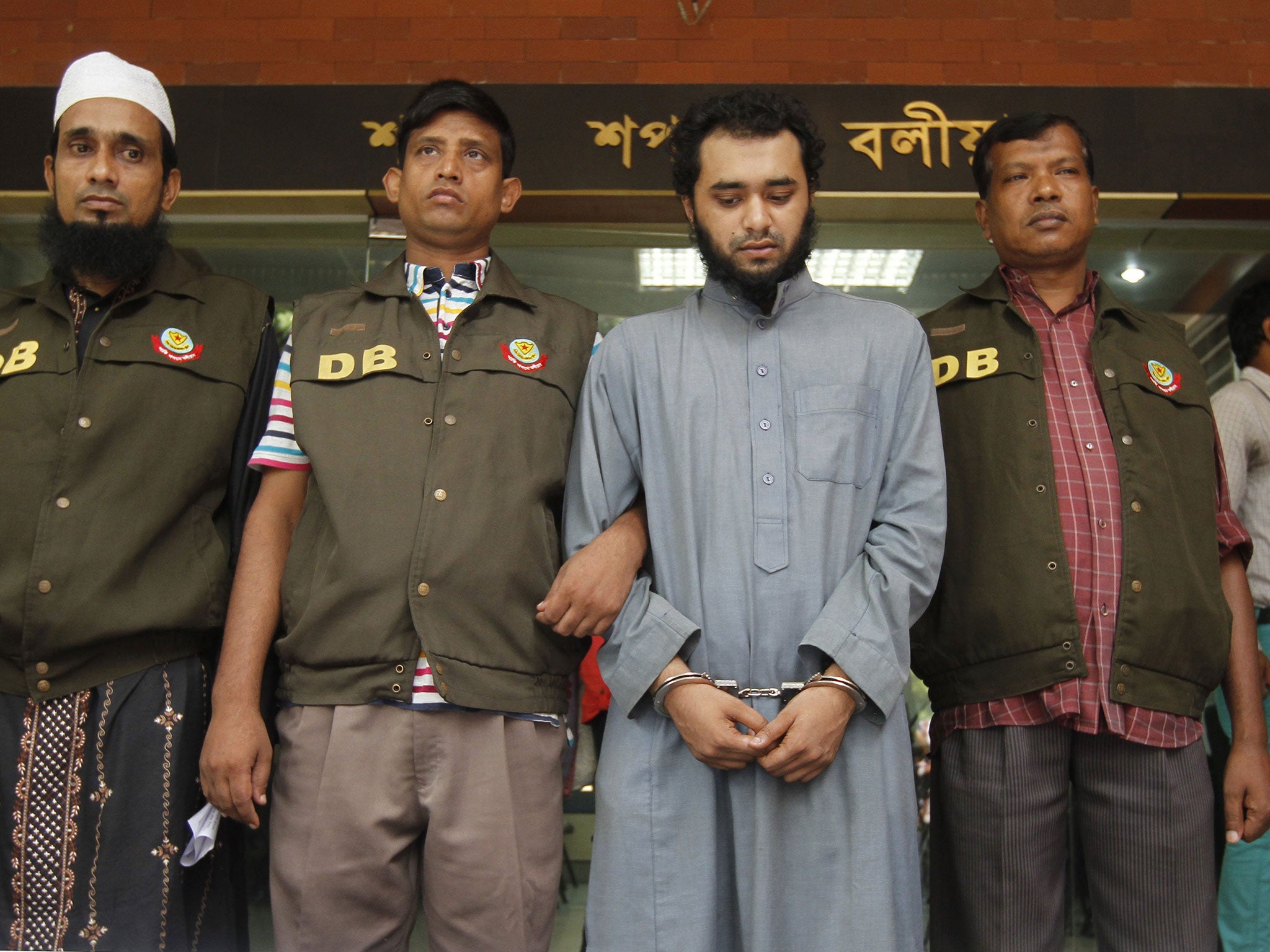 Samiun Rahman, centre, was re-arrested at a train station for the media’s benefit, according to a human rights group