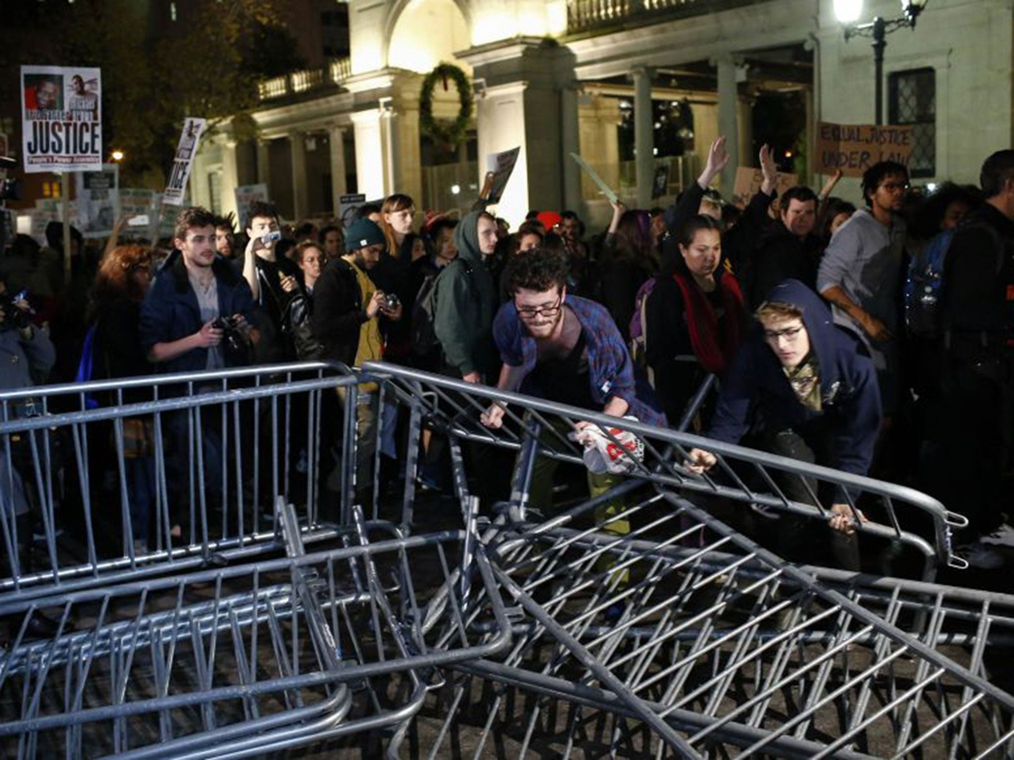 Protesters push over police barriers during a demonstration in New York's Times Square