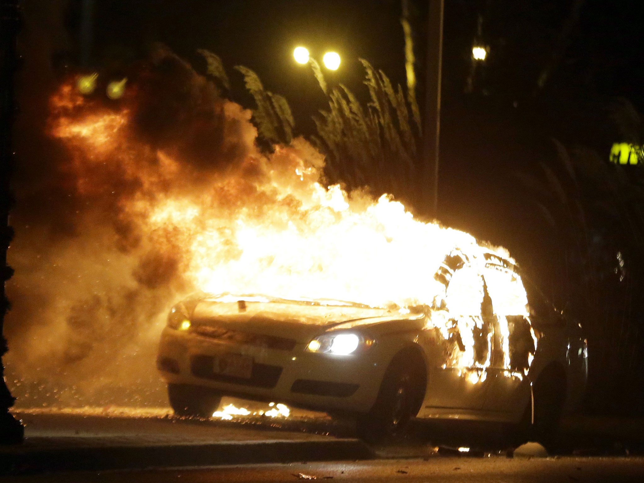 A police car burns in Ferguson, Missouri