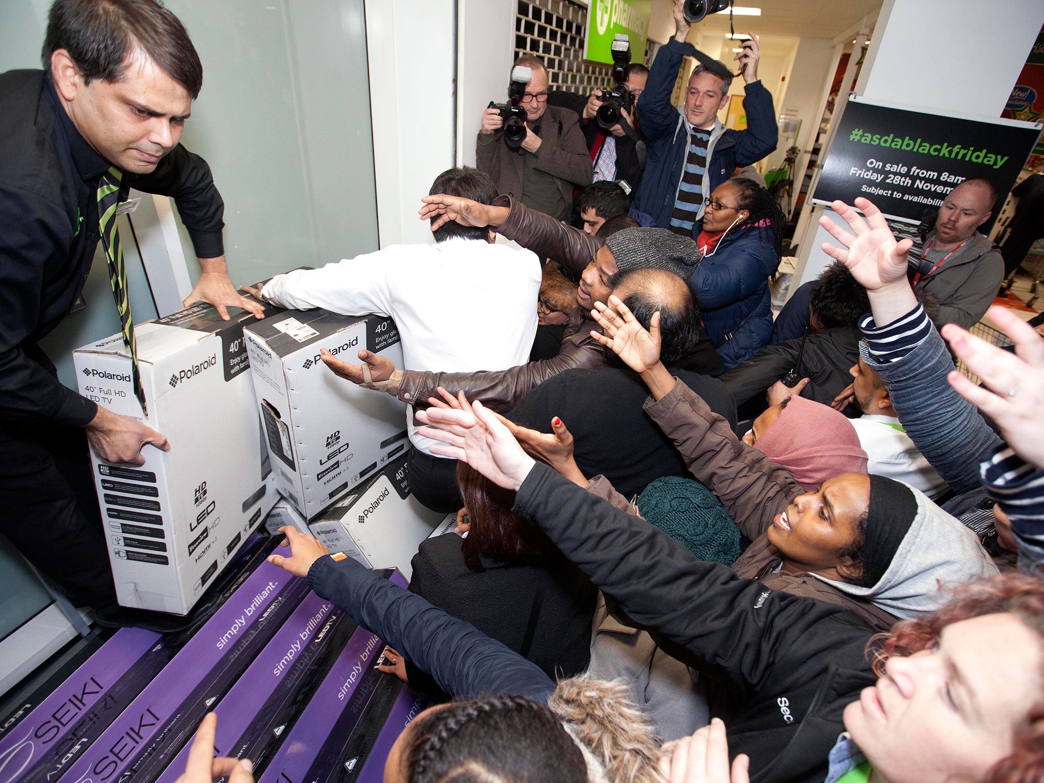 Shoppers try to grab items at the Asda store in Wembley