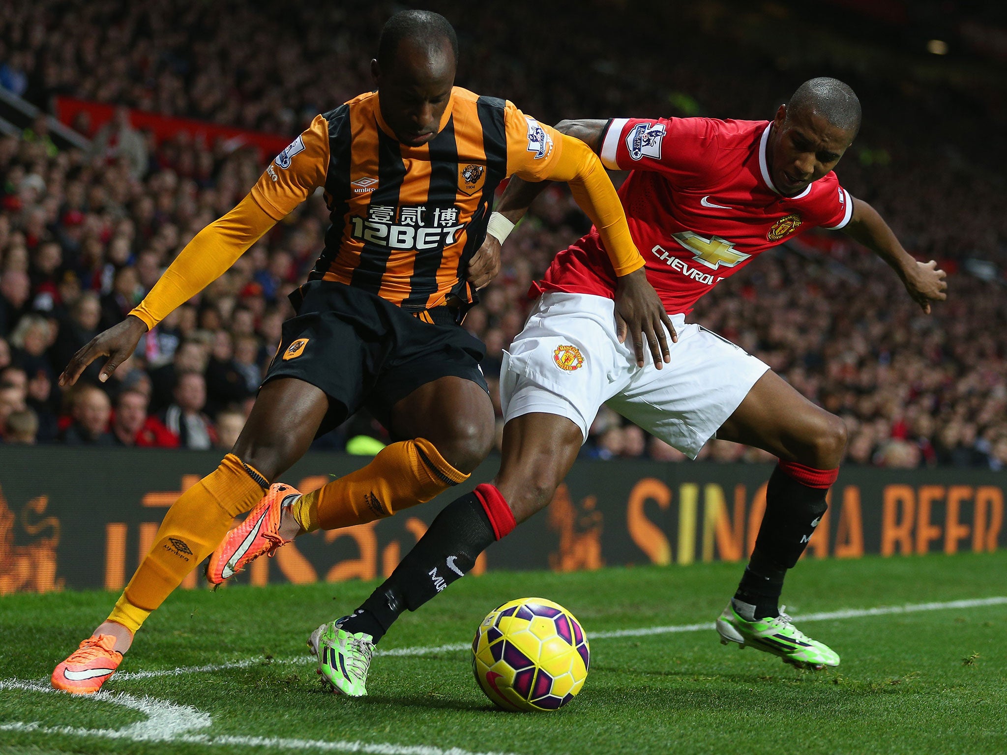 Sone Aluko challenges Ashley Young in the corner