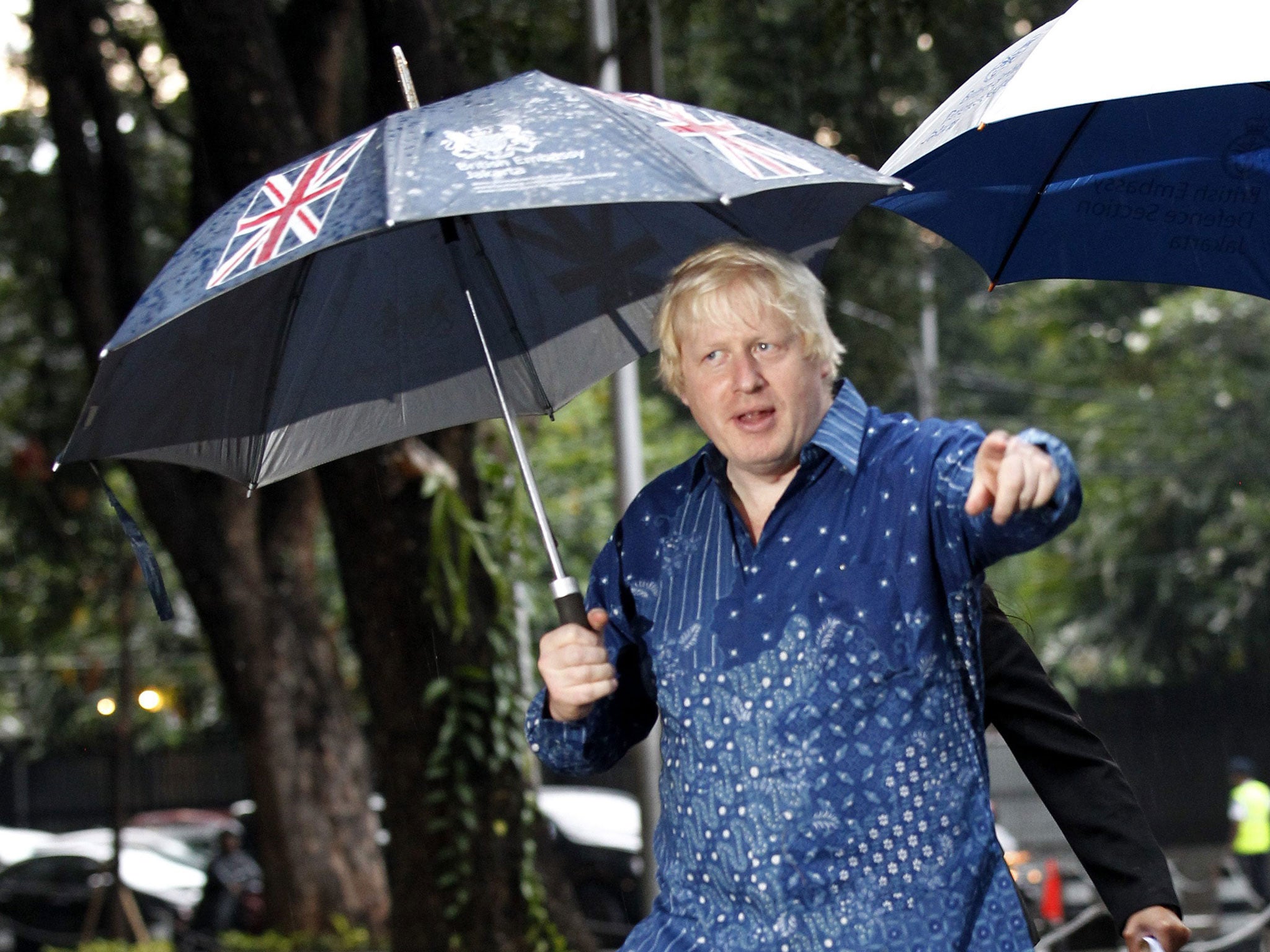 Boris Johnson walks through the drizzling rain for a meeting with Jakarta's Governor, Basuki Tjahya