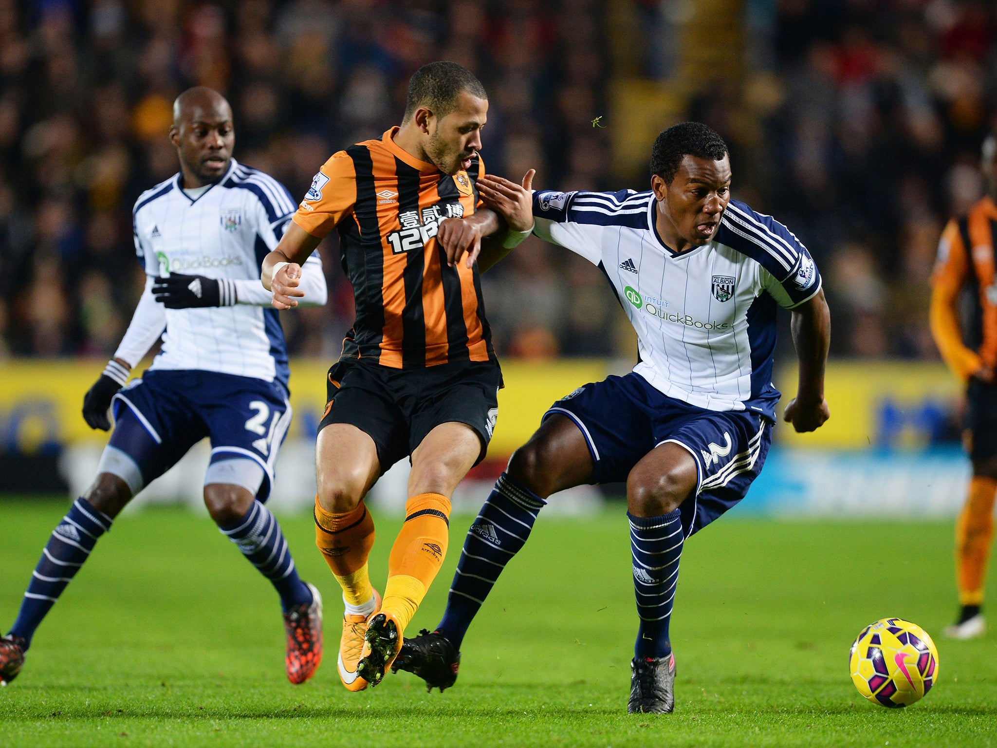 Liam Rosenior of Hull City and Andre Wisdom of West Brom compete for the ball