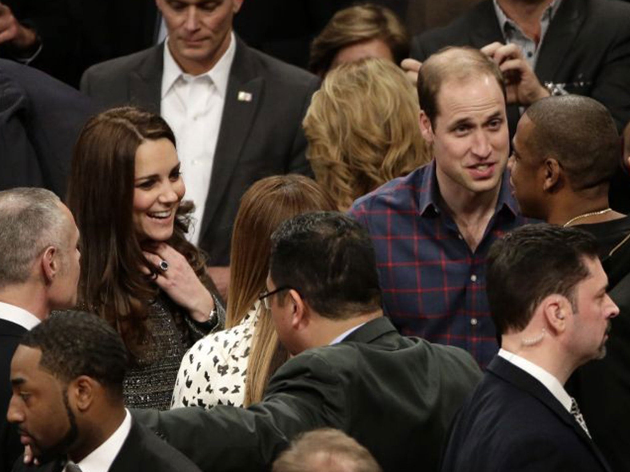 Prince William talks with Jay-Z , as the Duchess of Cambridge, chats with Beyonce during an NBA basketball game